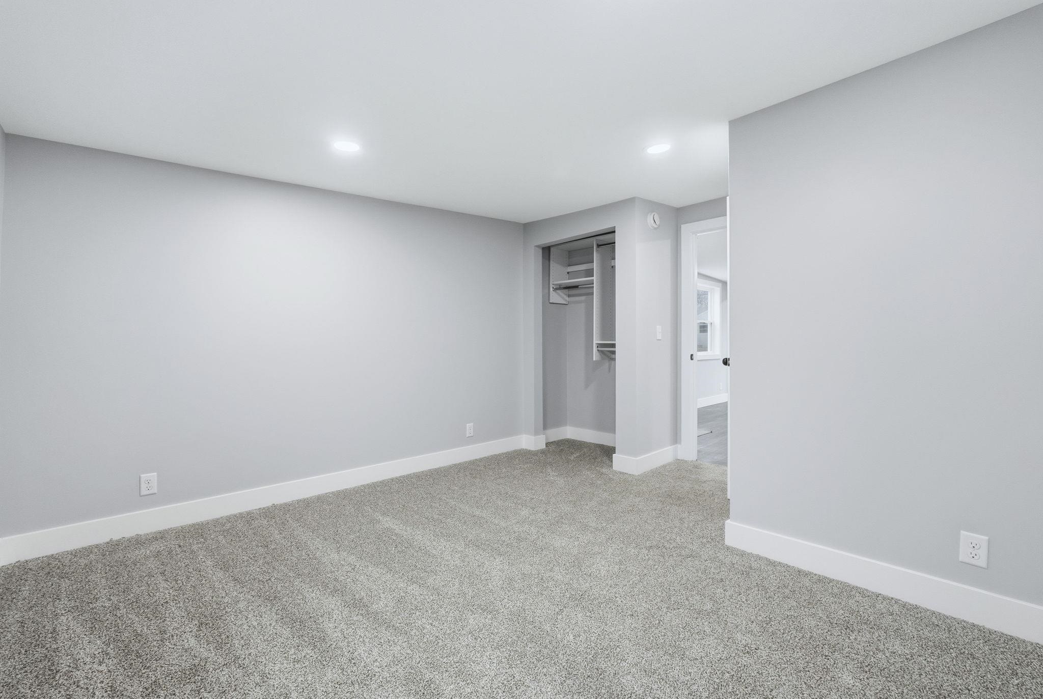 Unfurnished bedroom featuring light colored carpet, a closet, and recessed lighting