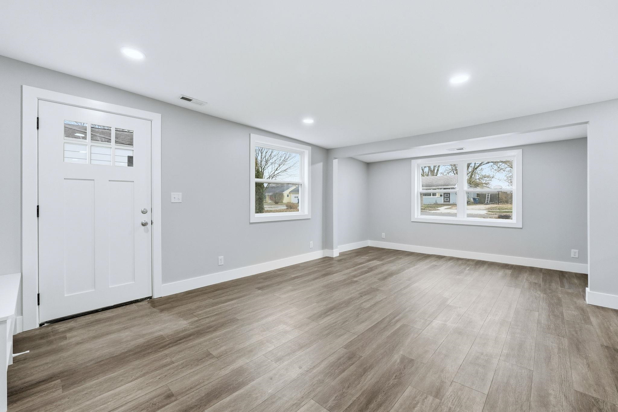 Entrance foyer with light wood-type flooring and recessed lighting