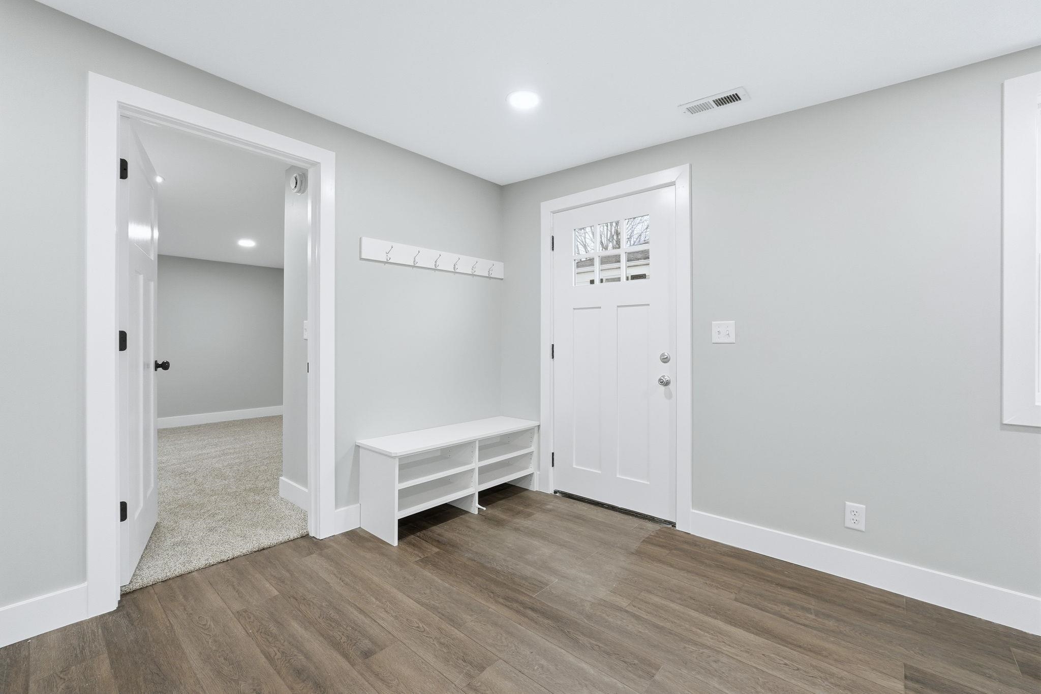 Foyer featuring wood finished floors and recessed lighting