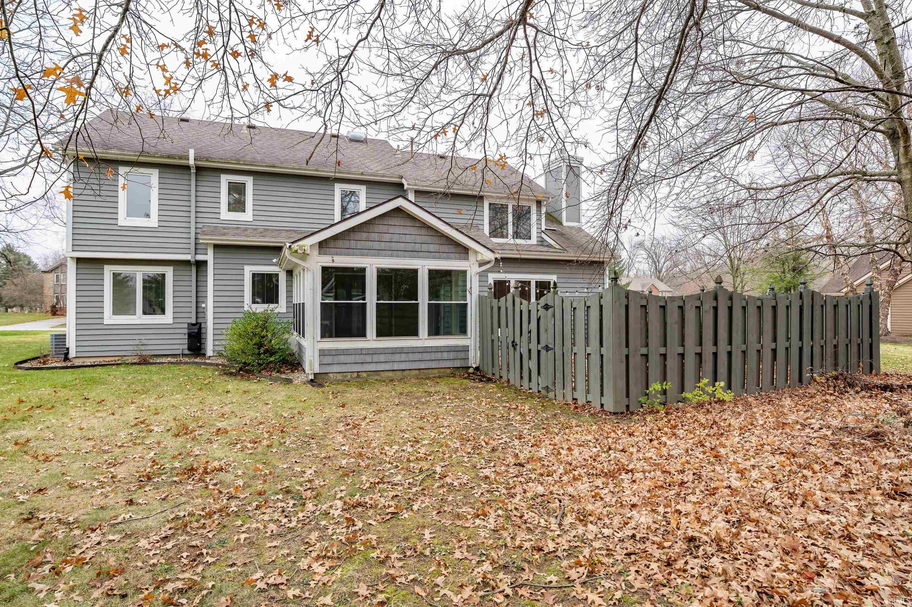 Back of house with a sunroom