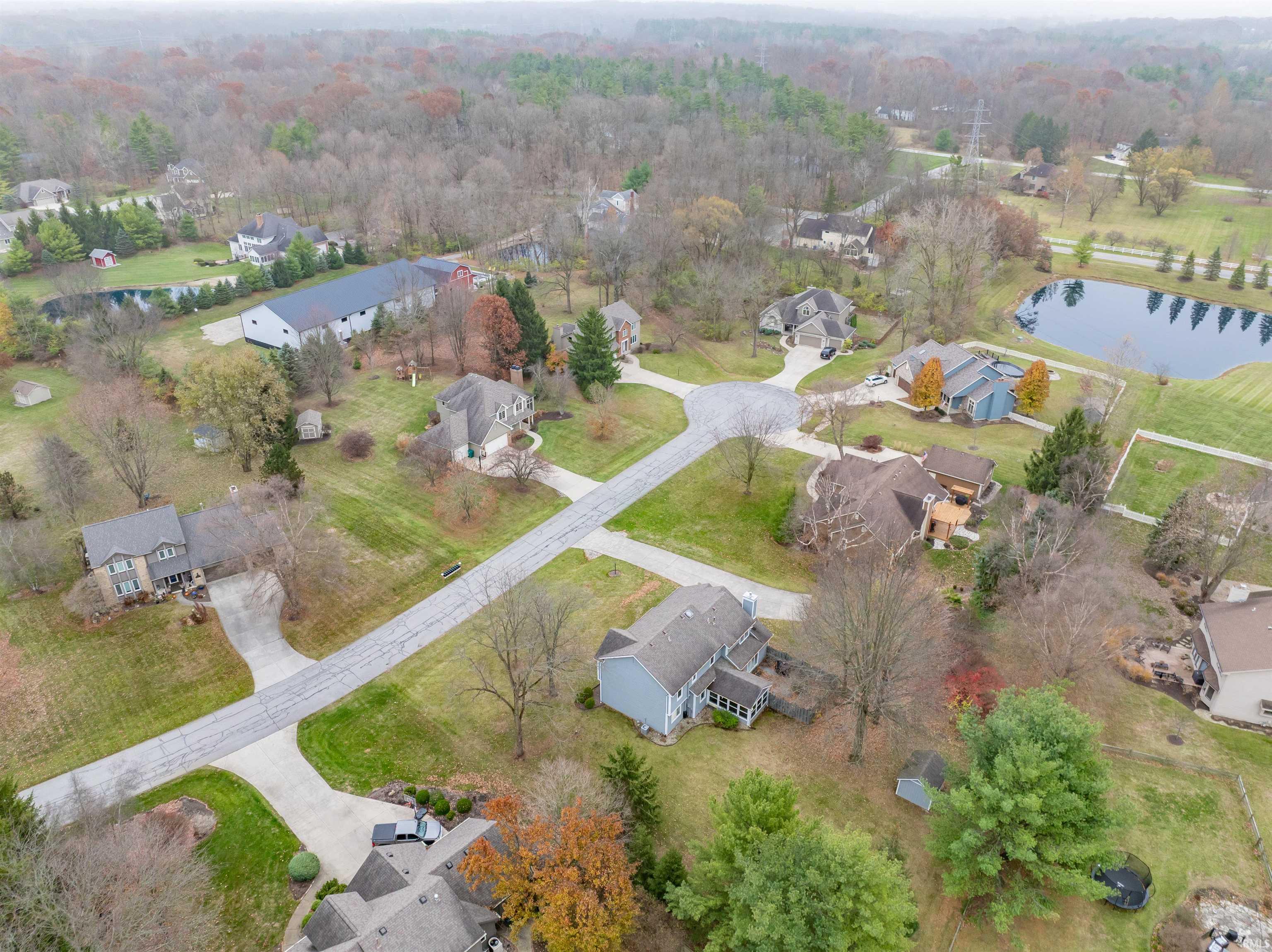 Aerial overview of property's location featuring nearby suburban area and a large body of water