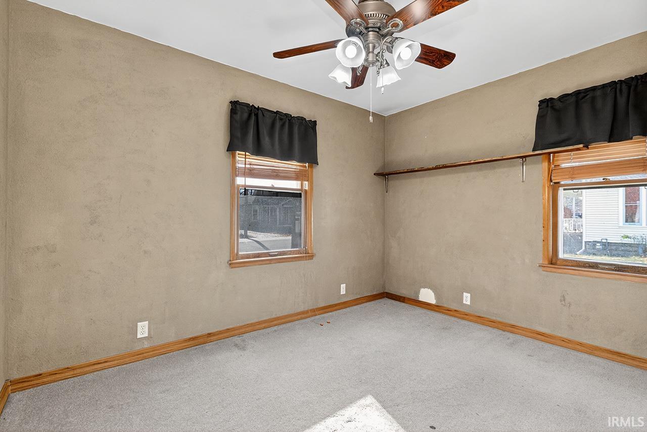 Spare room with carpet and a ceiling fan