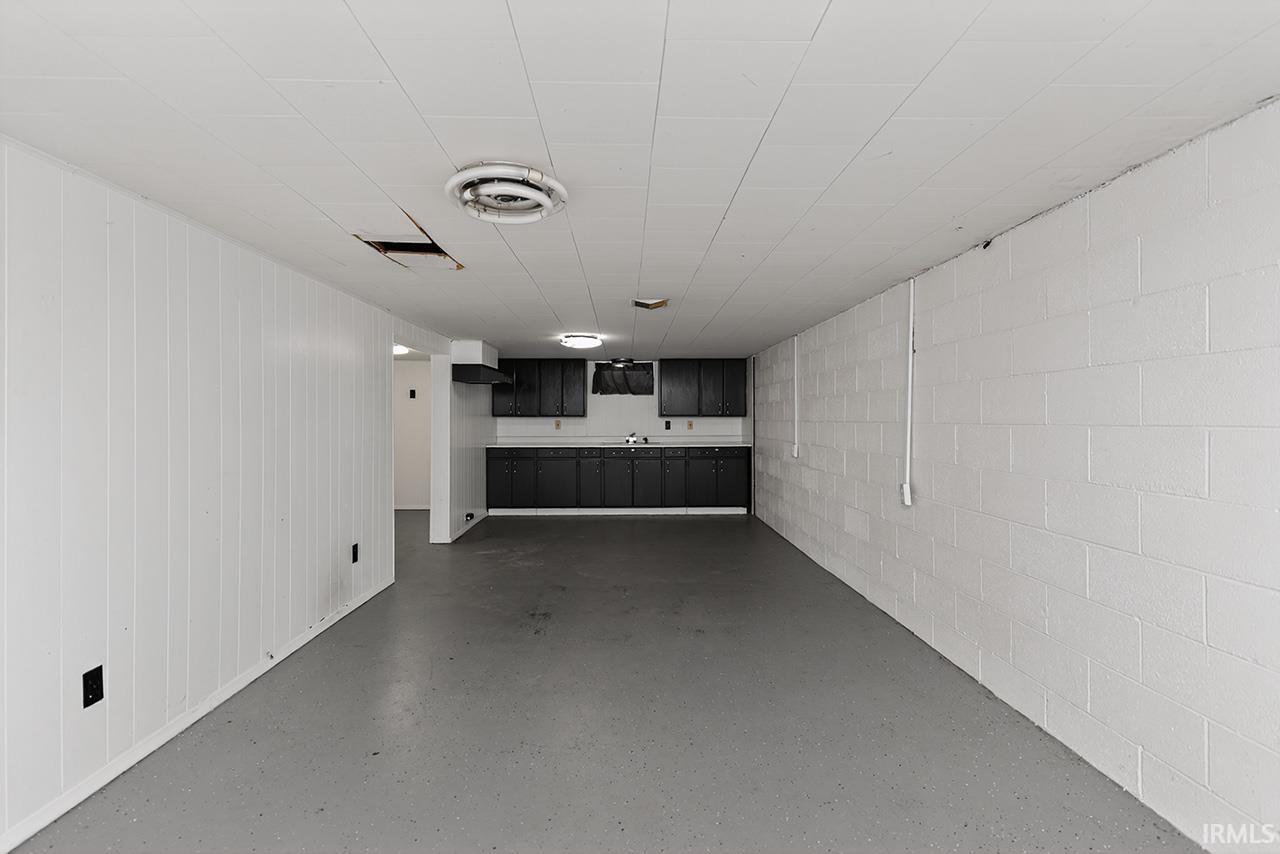 Finished below grade area featuring concrete block wall