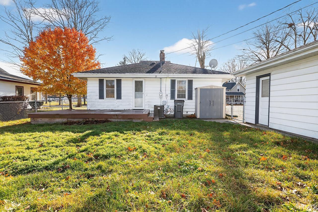 Rear view of property featuring a chimney and a deck