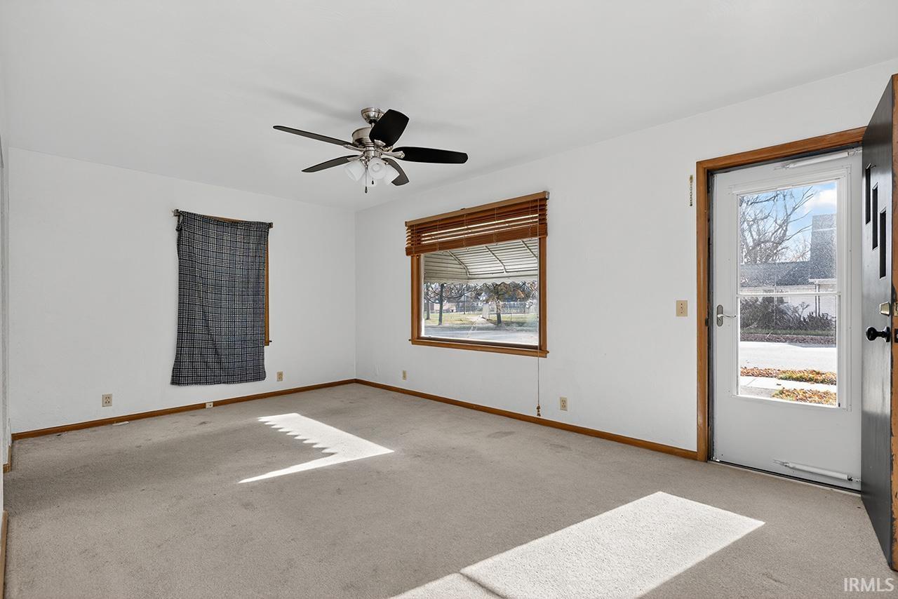 Unfurnished room with carpet floors and a ceiling fan