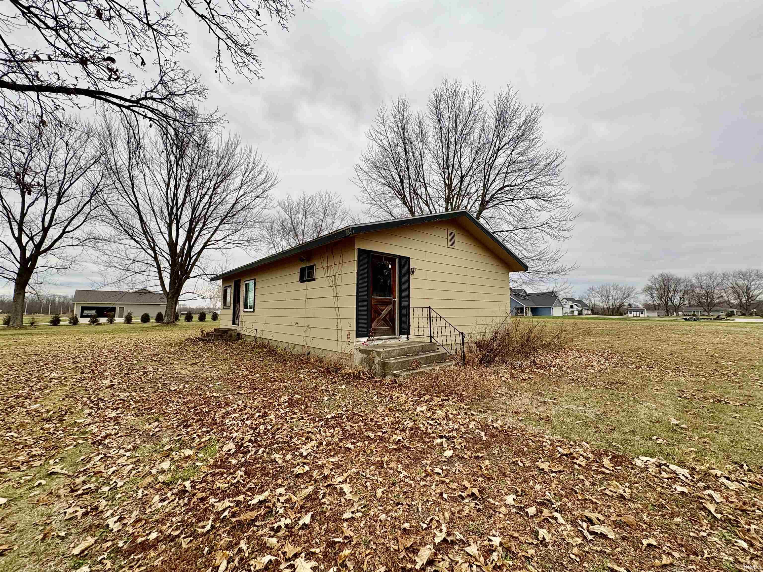 View of side of home featuring entry steps