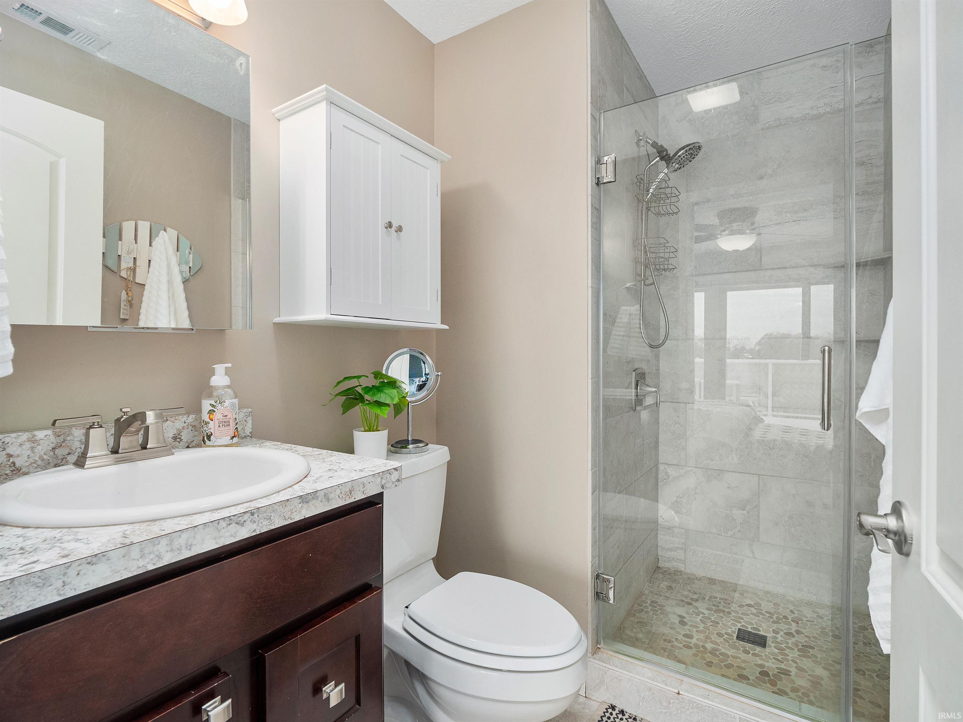Bathroom with vanity and a stall shower