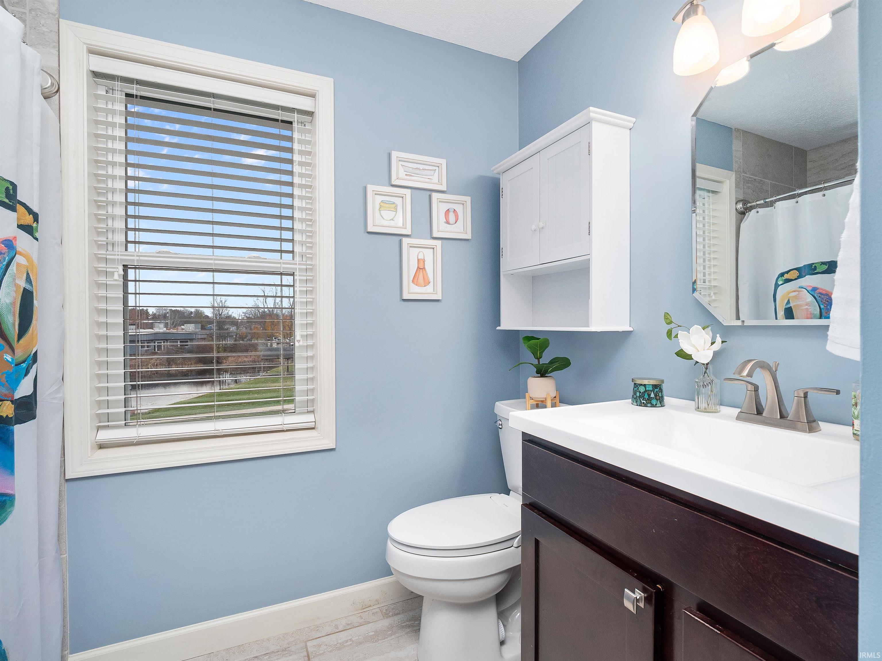 Full bath featuring a shower with shower curtain and vanity