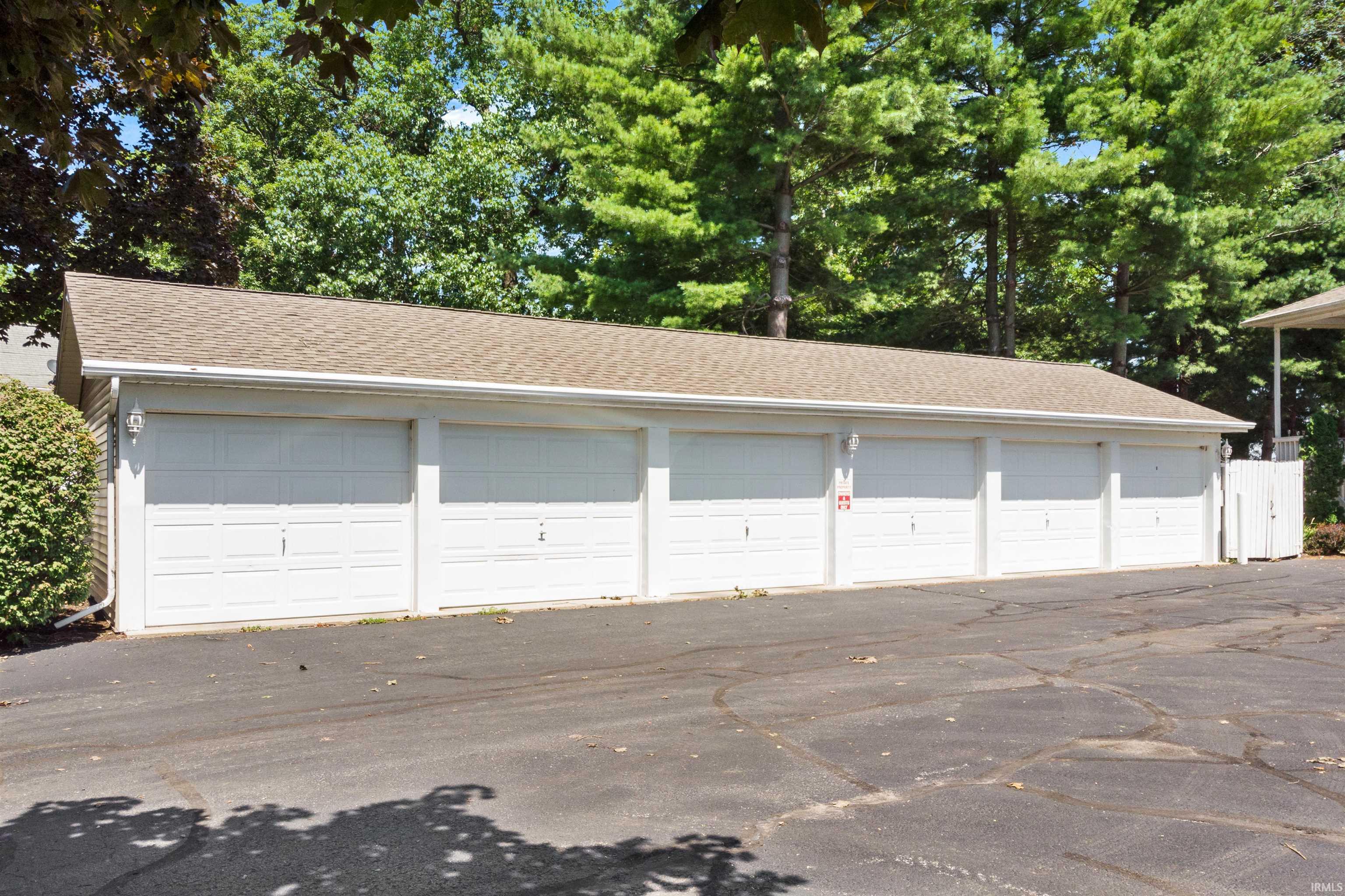 Garage featuring view of scattered trees