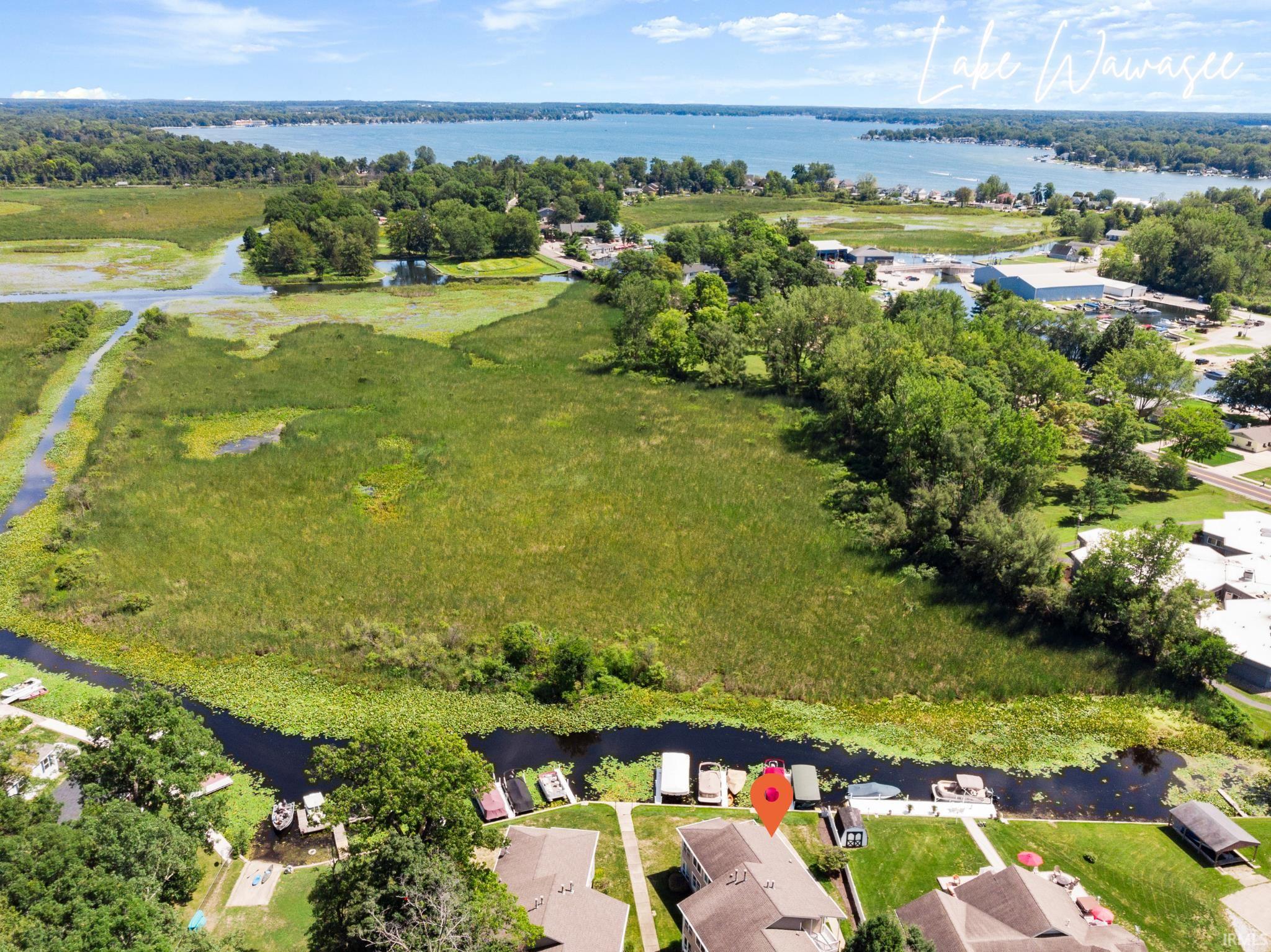 Aerial perspective of suburban area featuring a nearby body of water