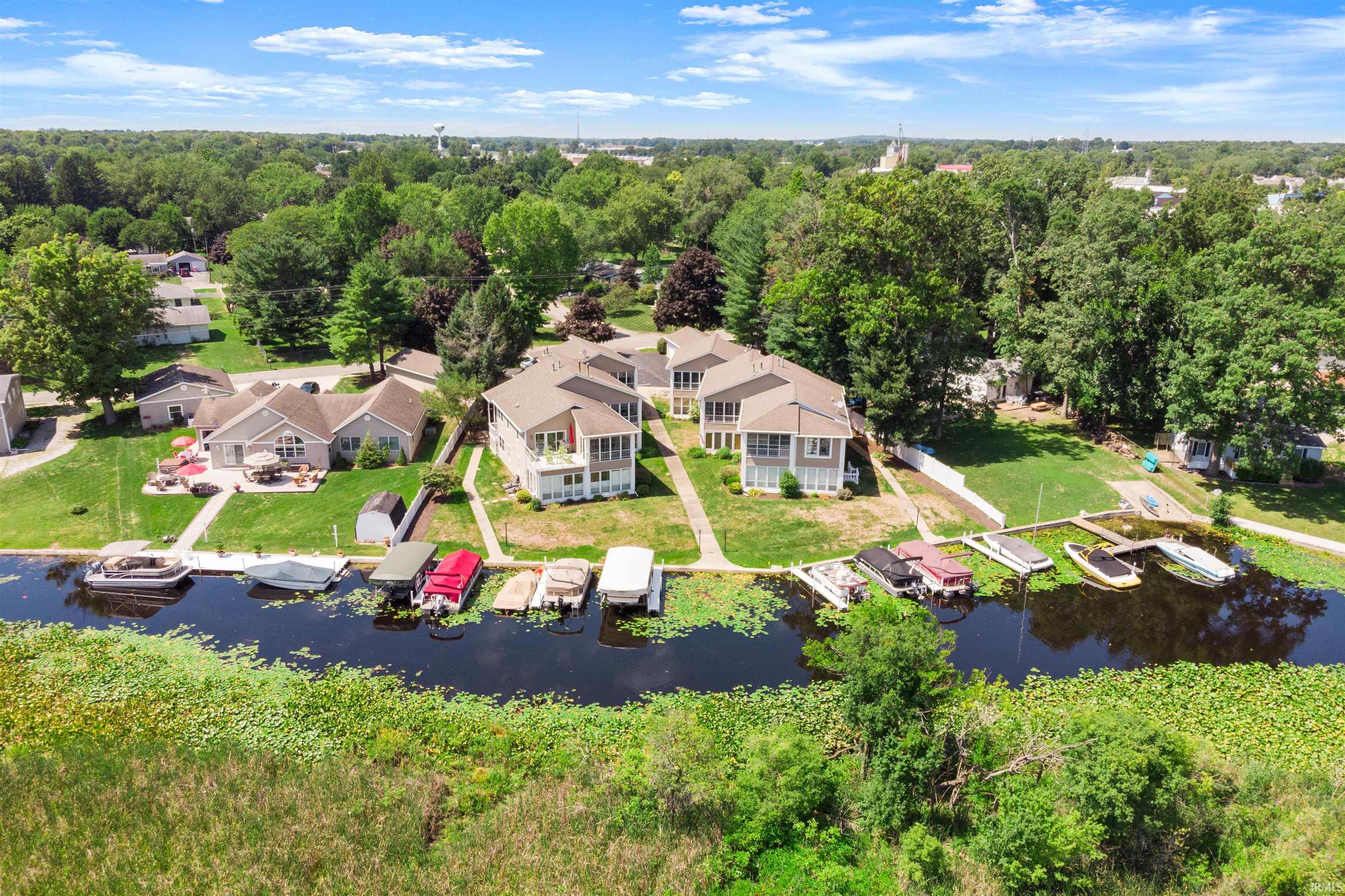 Drone / aerial view of a large body of water and a tree filled landscape