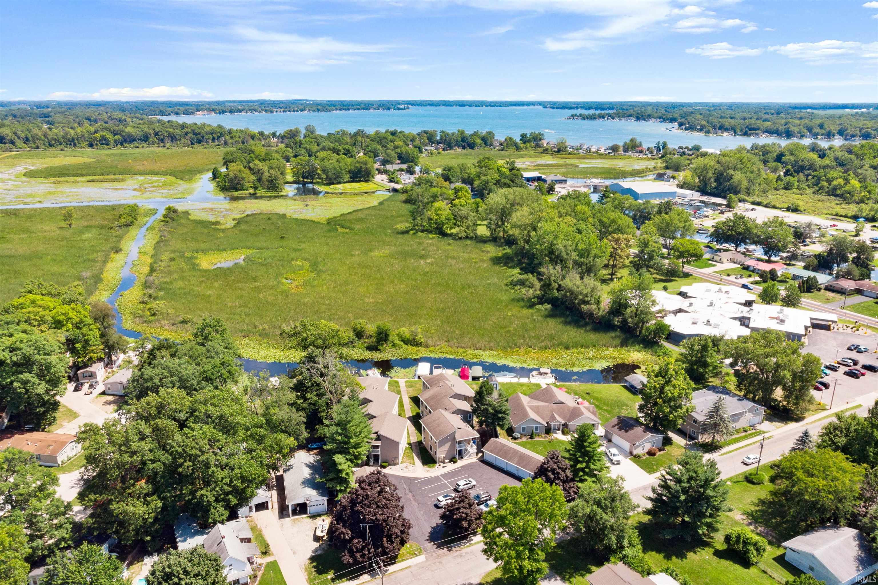 Aerial perspective of suburban area featuring a nearby body of water
