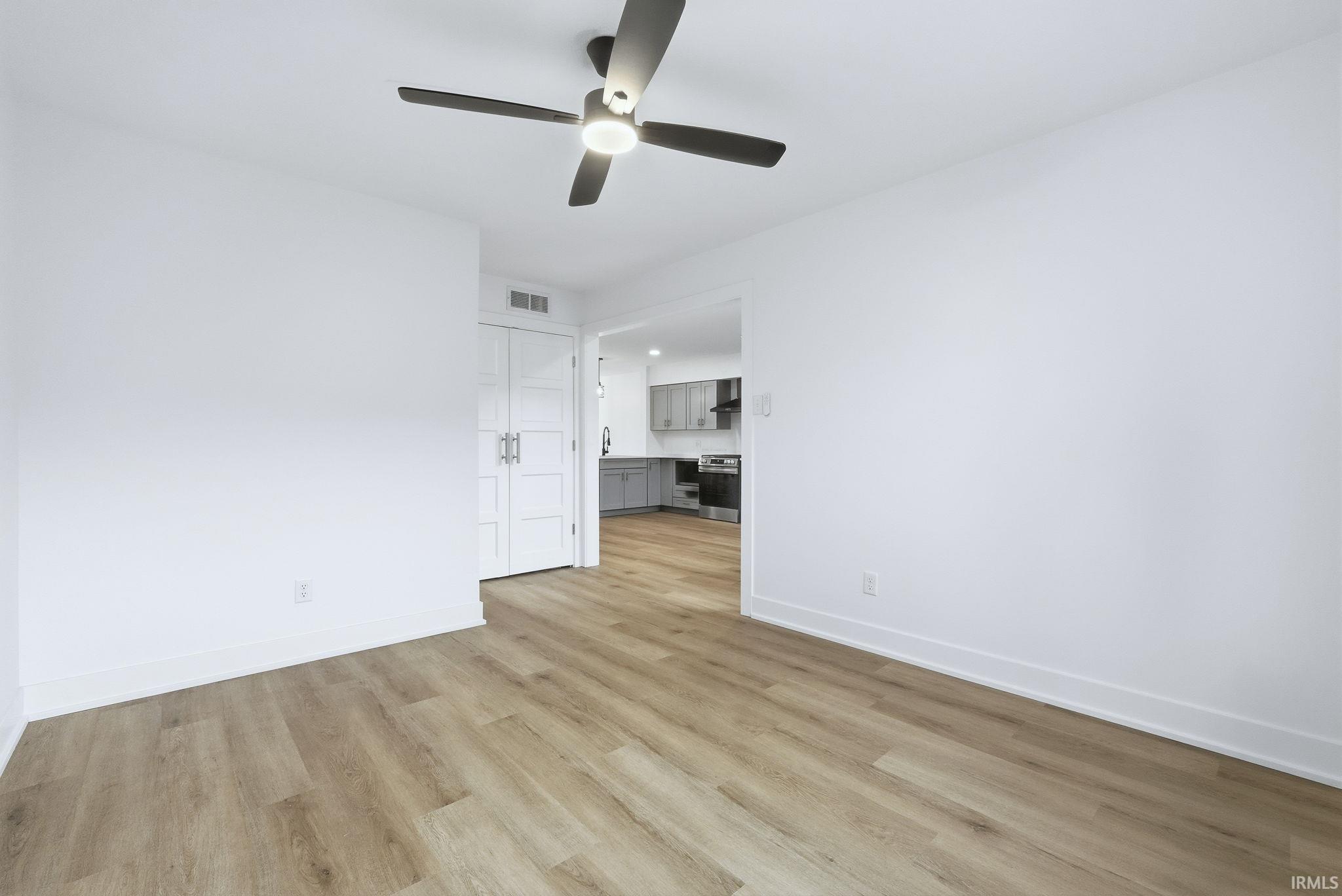 Spare room with light wood-style flooring and ceiling fan