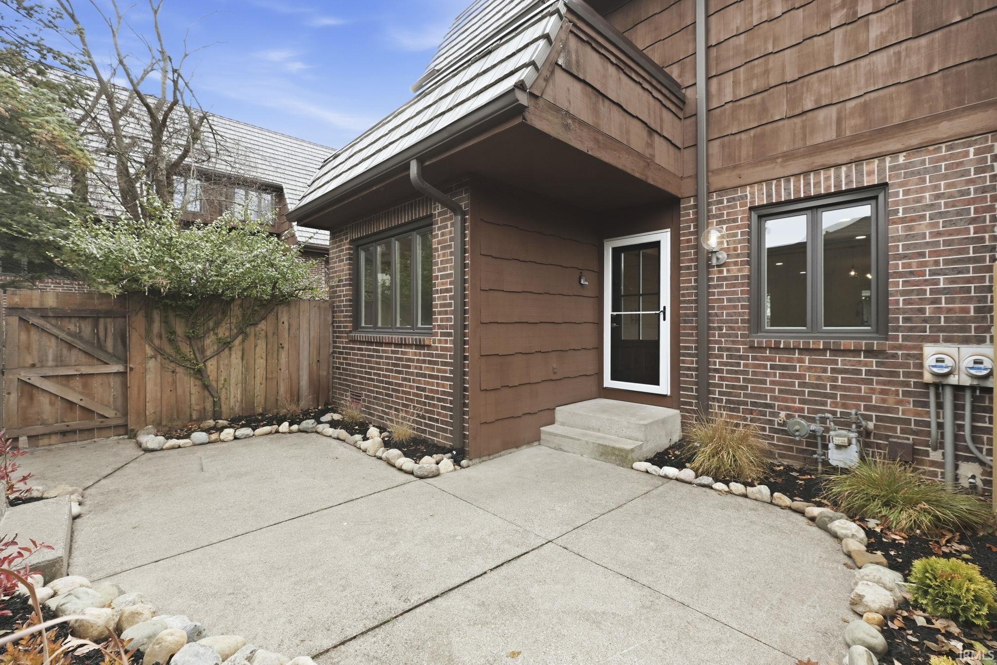 View of patio featuring a gate