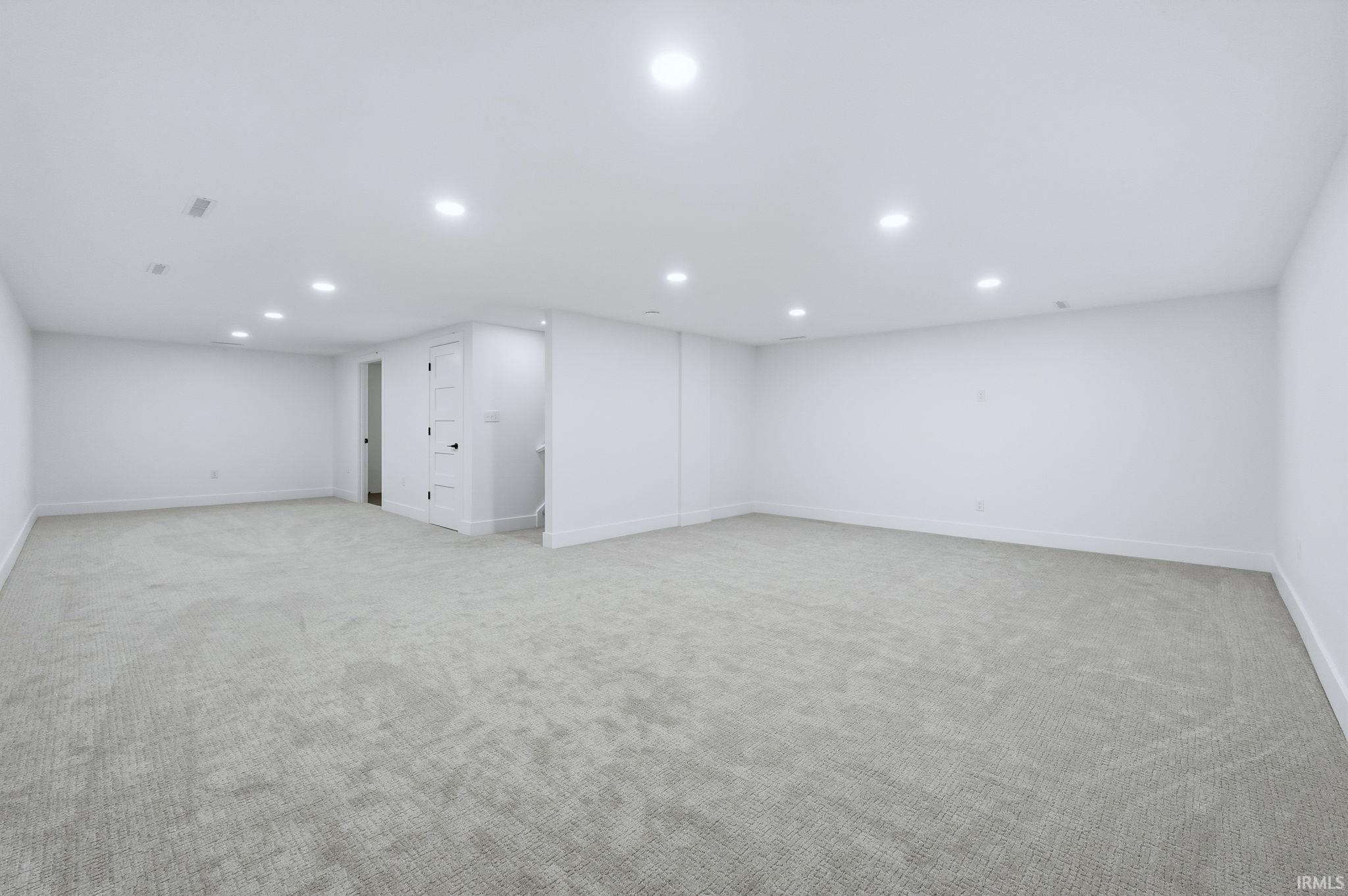 Finished basement featuring light carpet and recessed lighting
