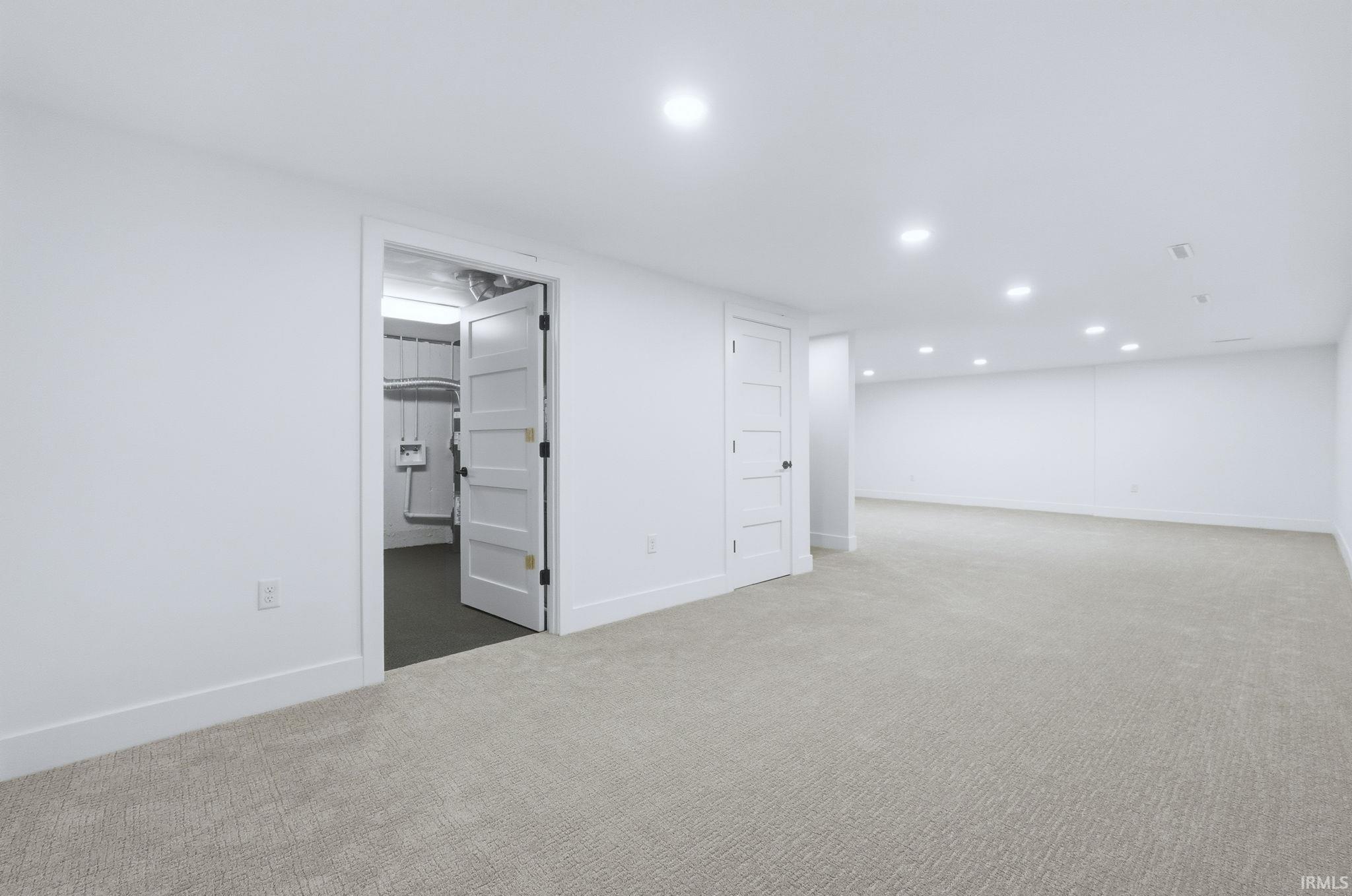 Finished below grade area featuring carpet floors and recessed lighting