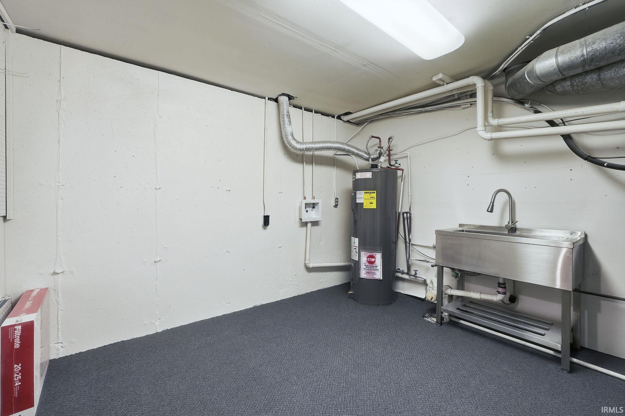 Basement featuring electric water heater