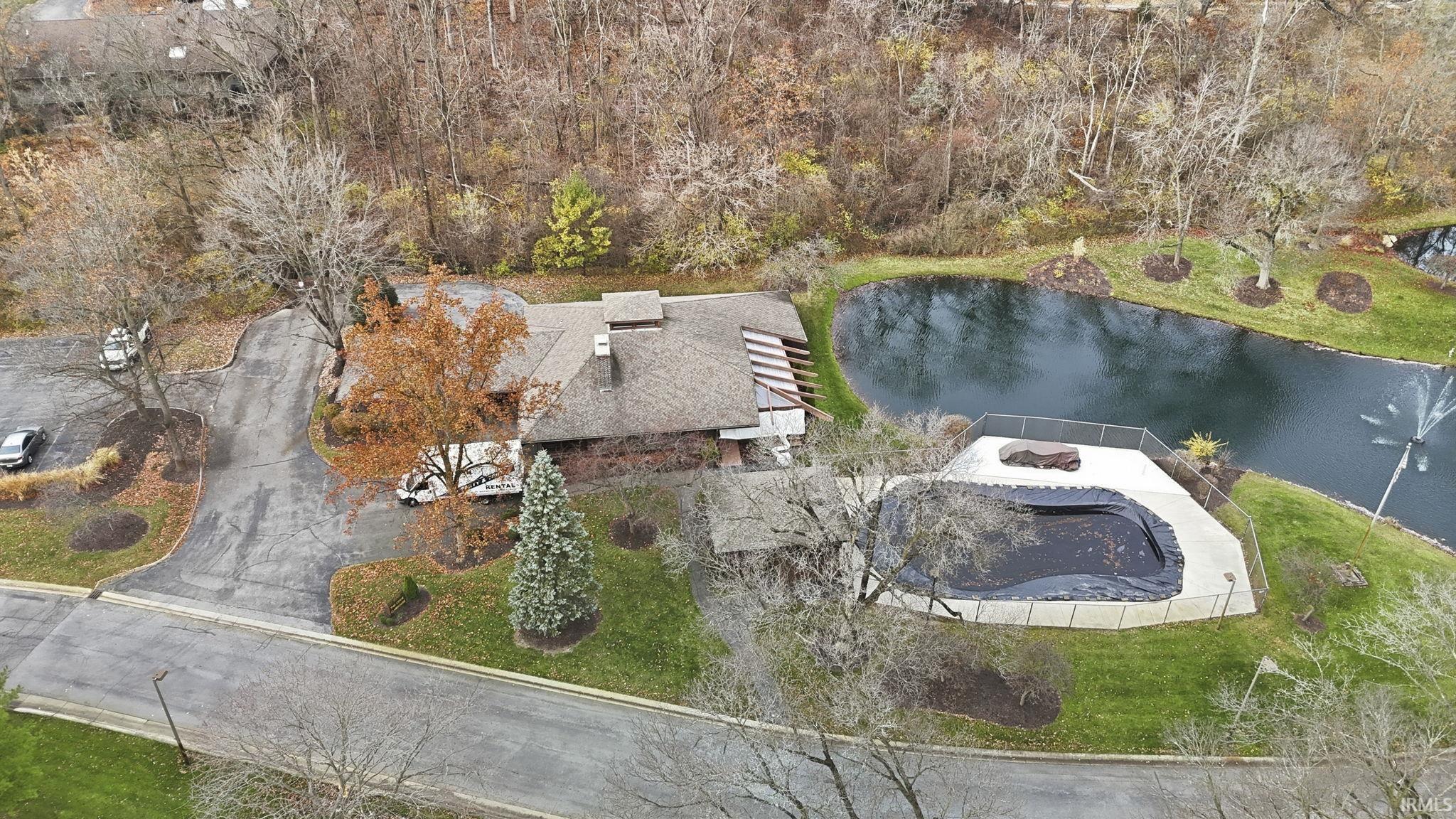 Aerial view of property and surrounding area with a large body of water