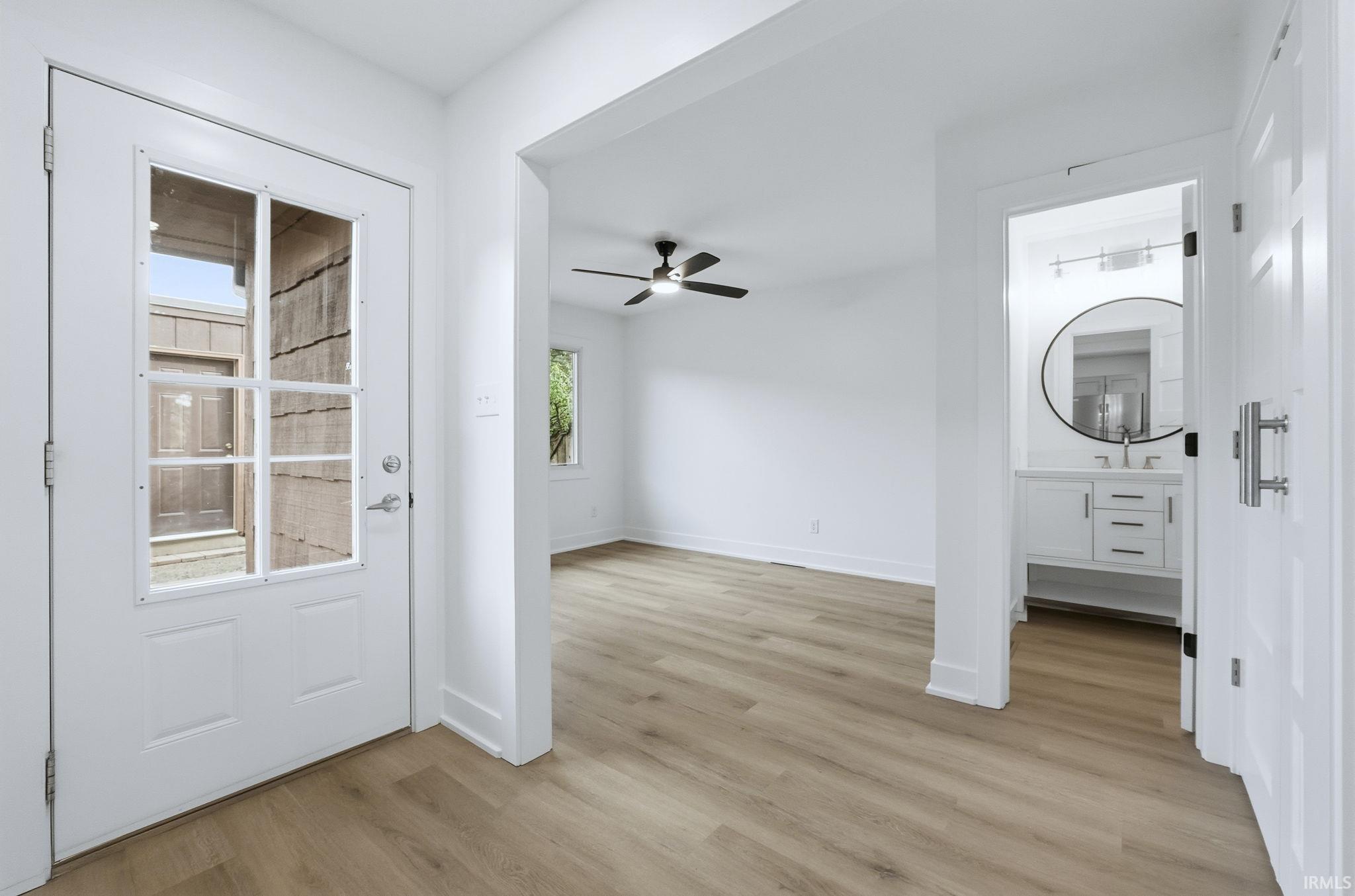 Foyer entrance featuring light wood-type flooring and ceiling fan