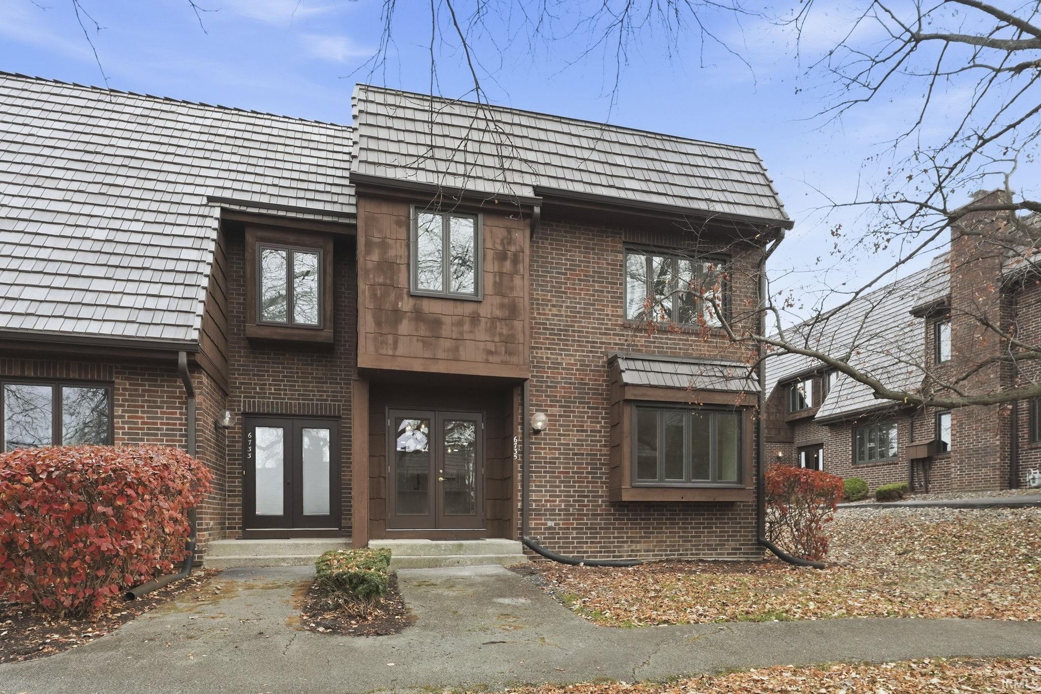View of front of property featuring brick siding and french doors