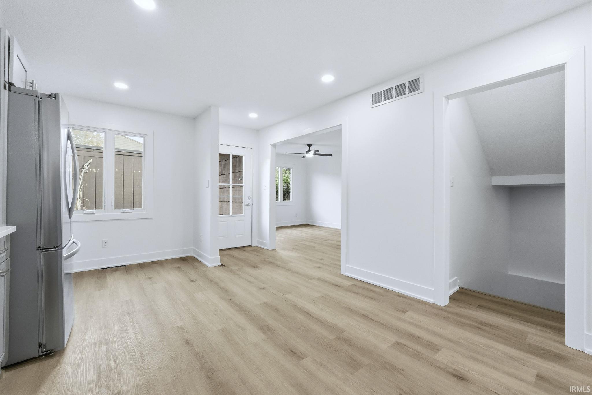 Unfurnished dining area with light wood finished floors, a ceiling fan, and recessed lighting