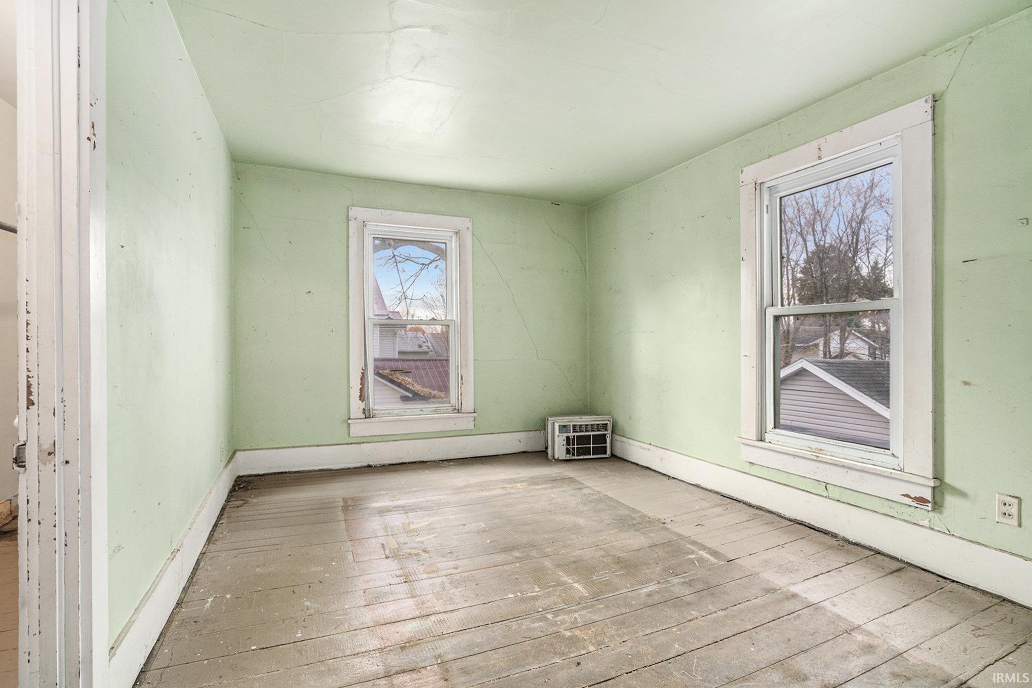 Unfurnished room featuring wood-type flooring and baseboards