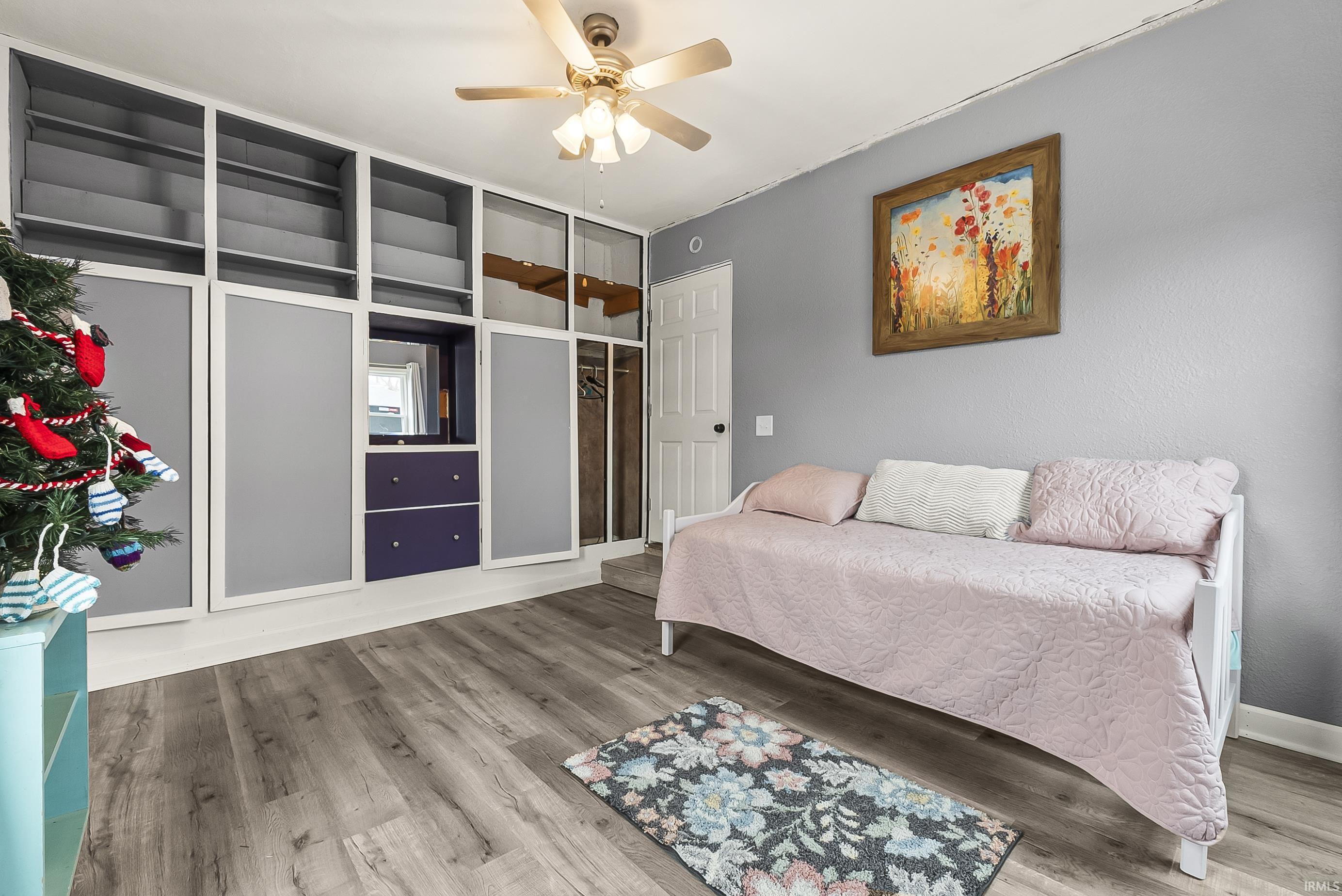 Bedroom with wood finished floors and ceiling fan