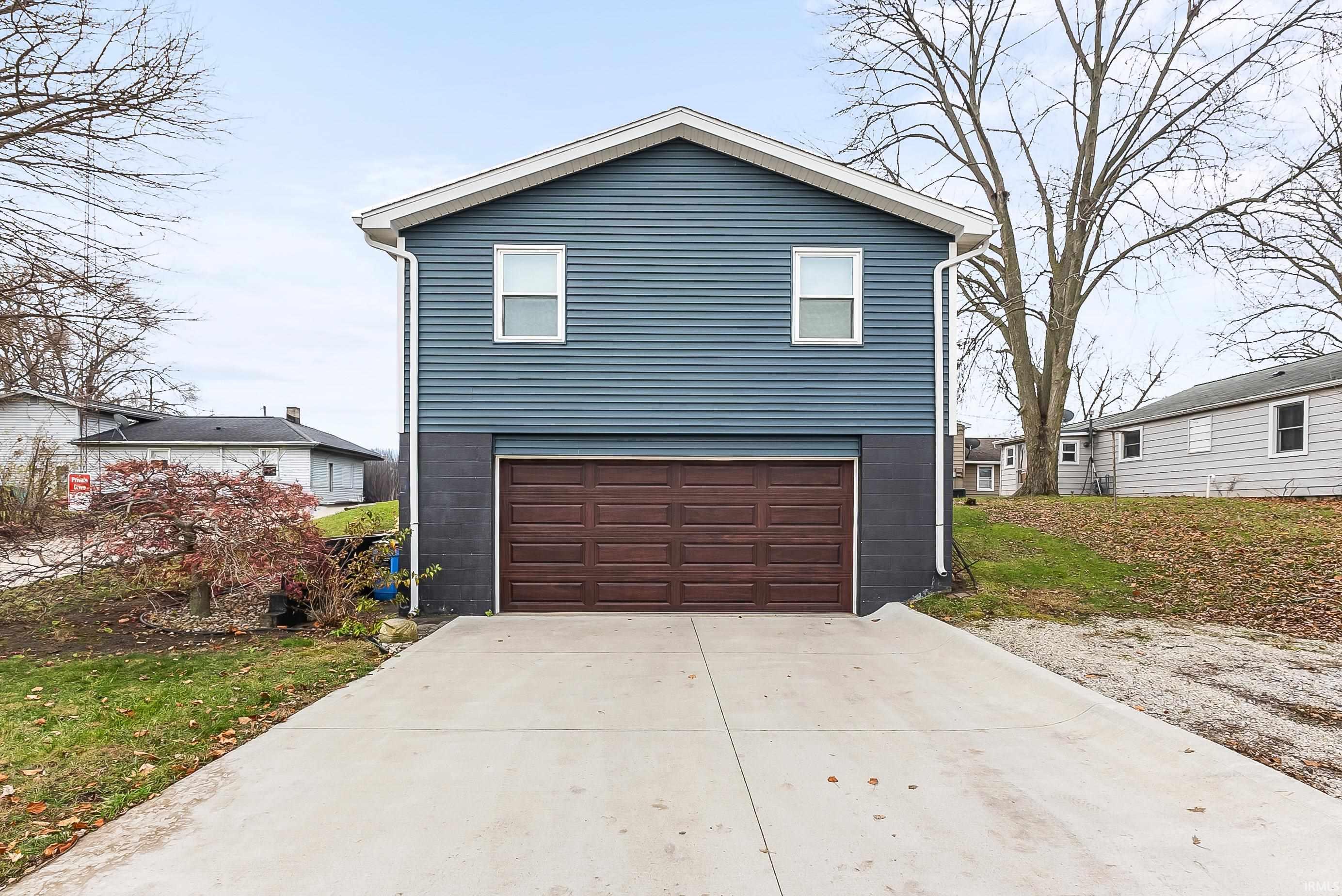 View of front of house with concrete driveway