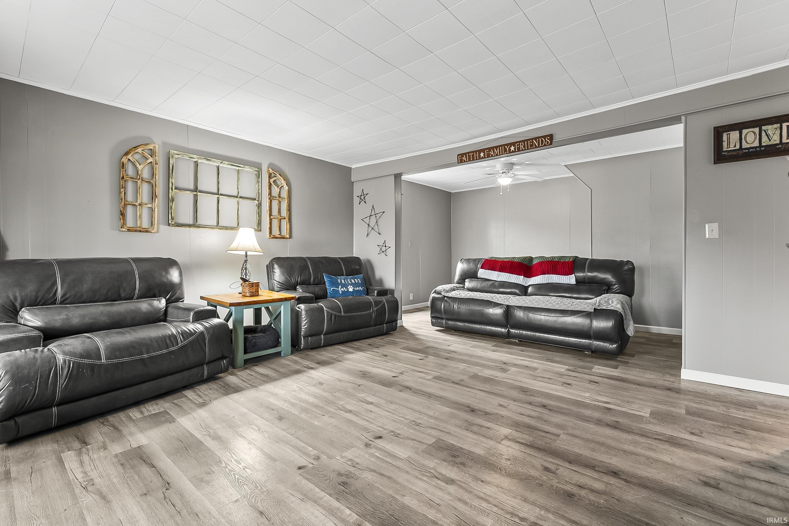 Living area with a ceiling fan and wood finished floors