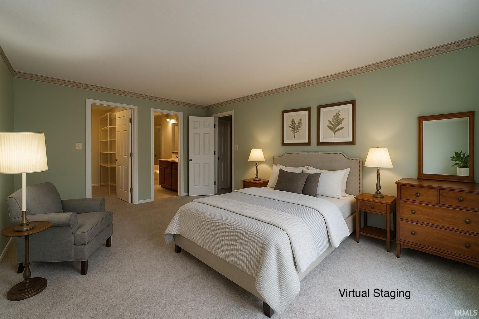 Bedroom featuring a walk in closet, carpet flooring, and ensuite bathroom