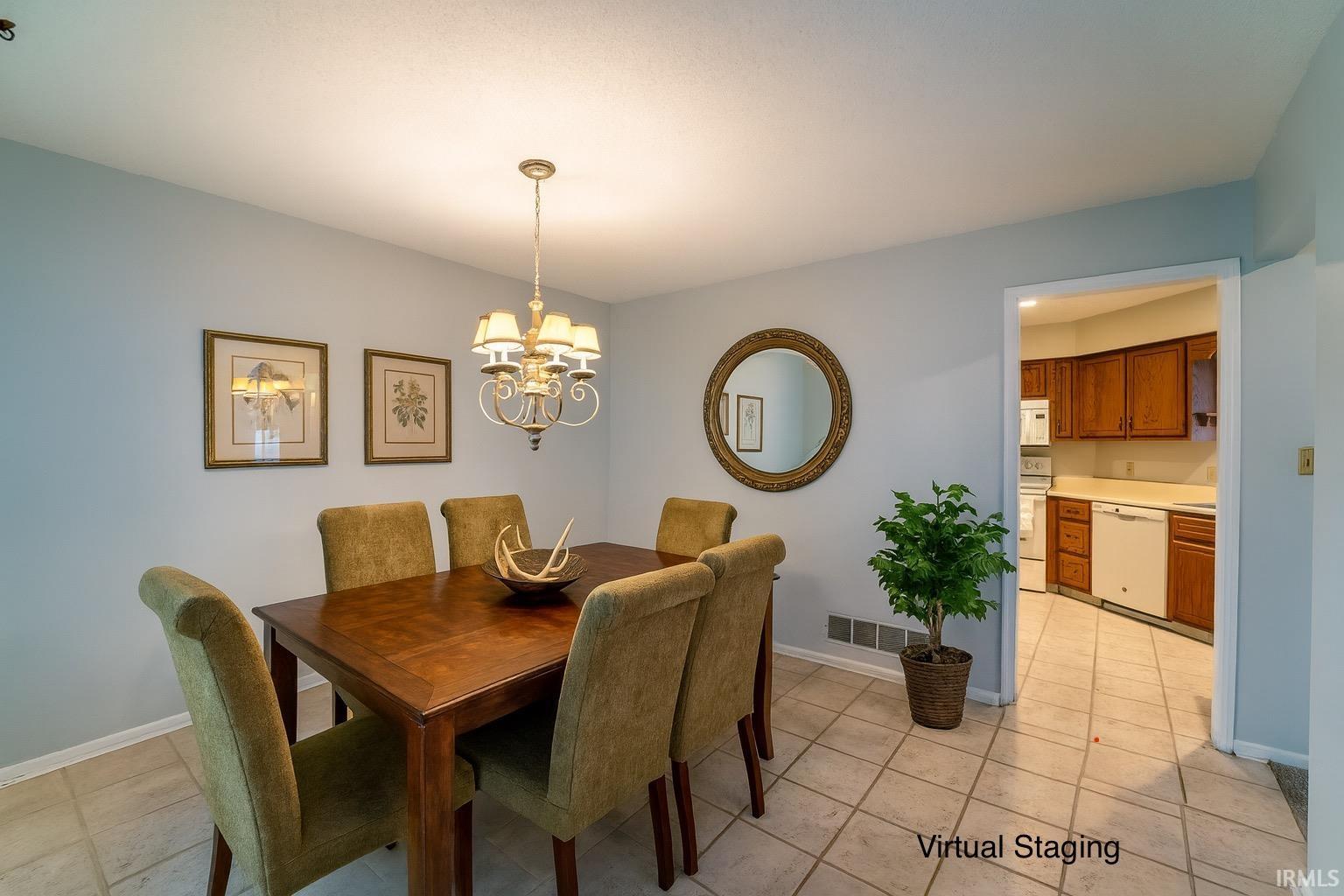 Dining room featuring a chandelier and light tile patterned flooring