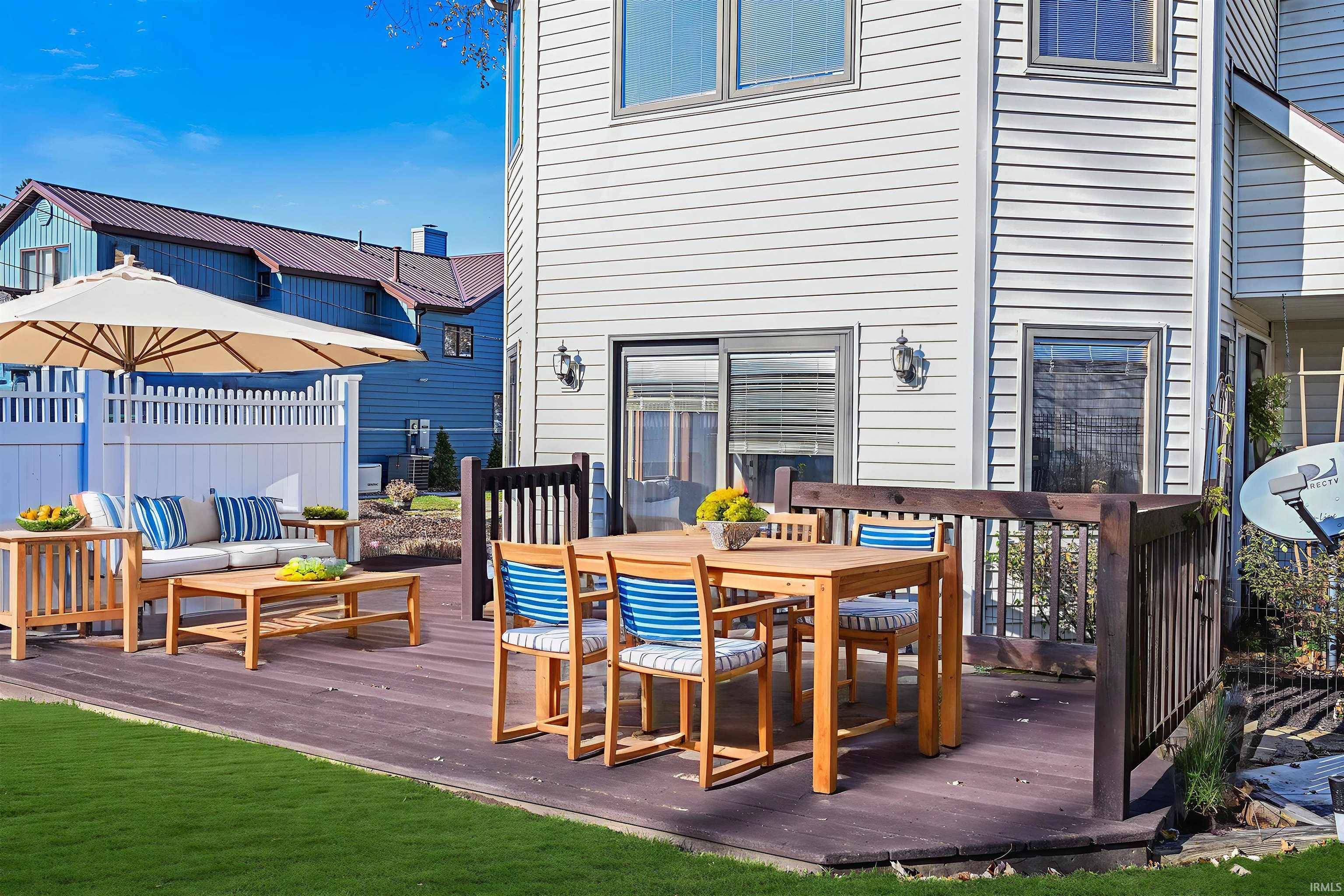 Wooden terrace with outdoor dining area and a gazebo