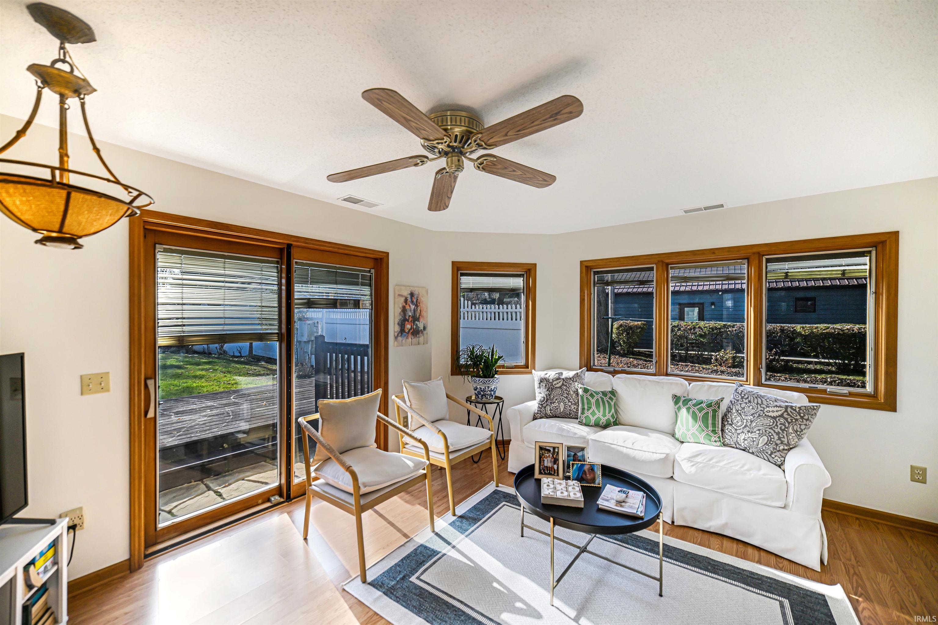 Living area featuring wood finished floors and ceiling fan