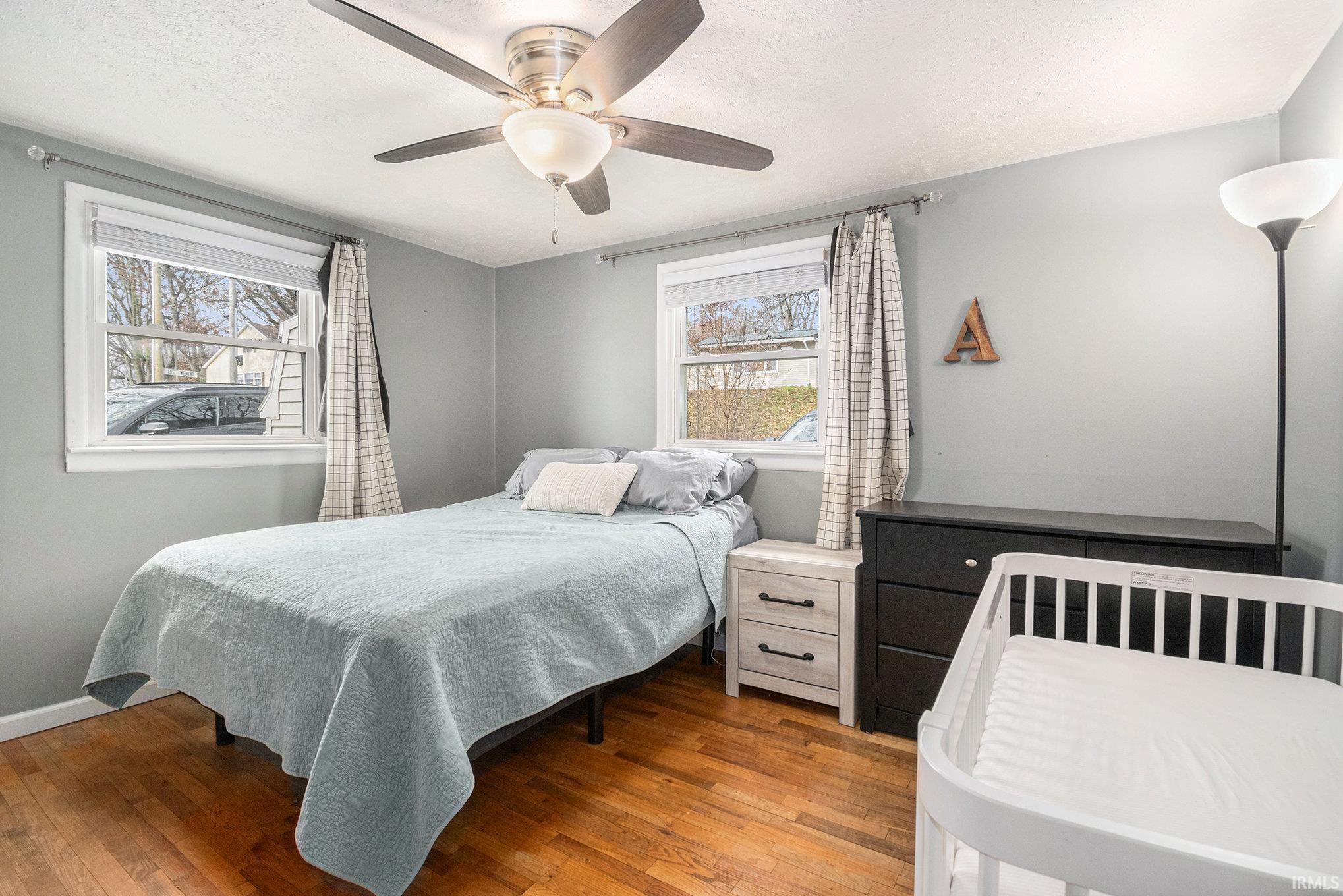 Bedroom with wood-type flooring and ceiling fan