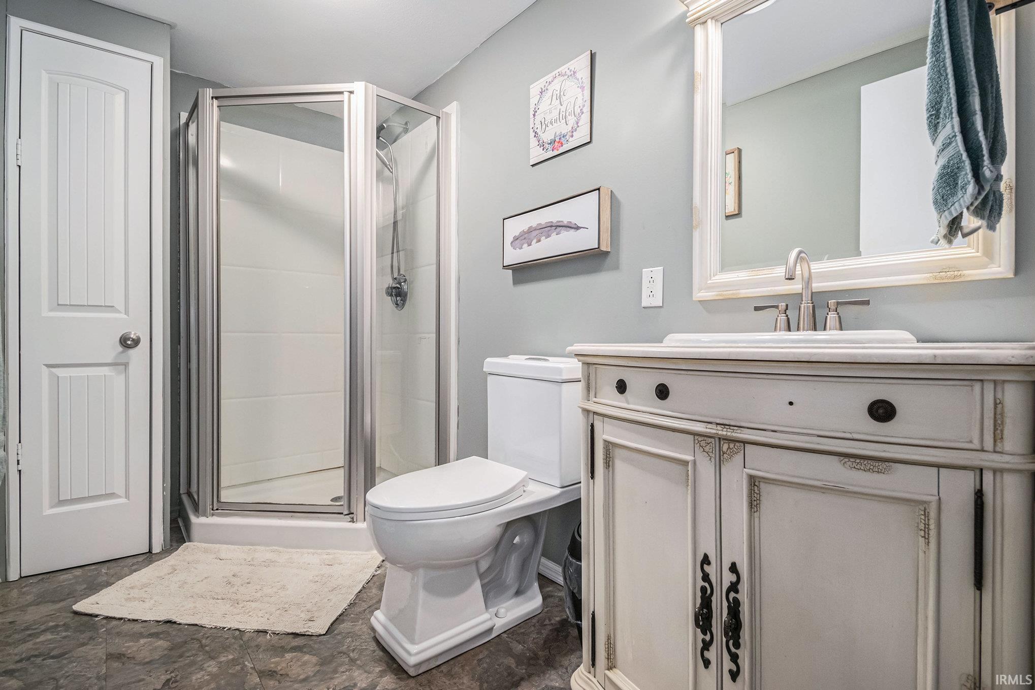 Full bathroom with a stall shower and vanity