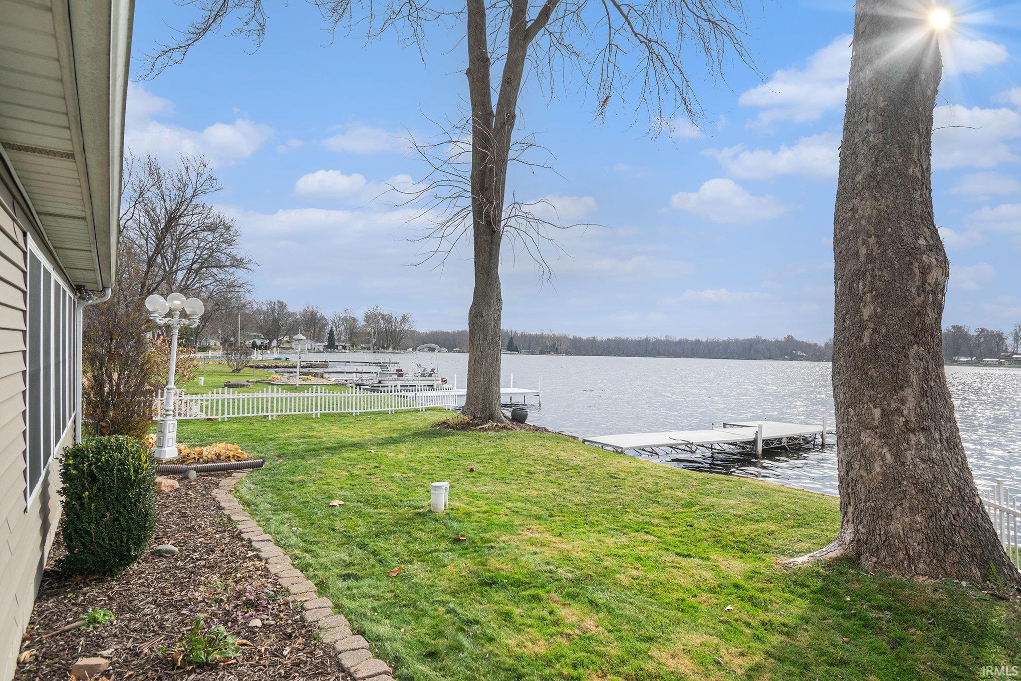 View of yard featuring a water view and a dock