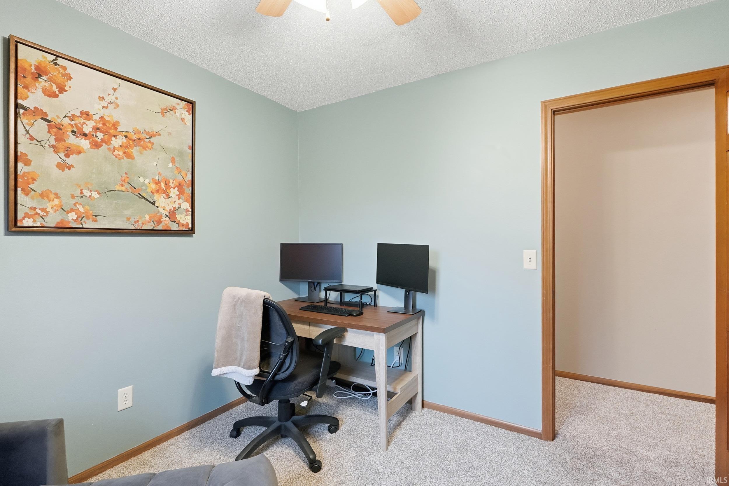 Office featuring carpet, a textured ceiling, and ceiling fan