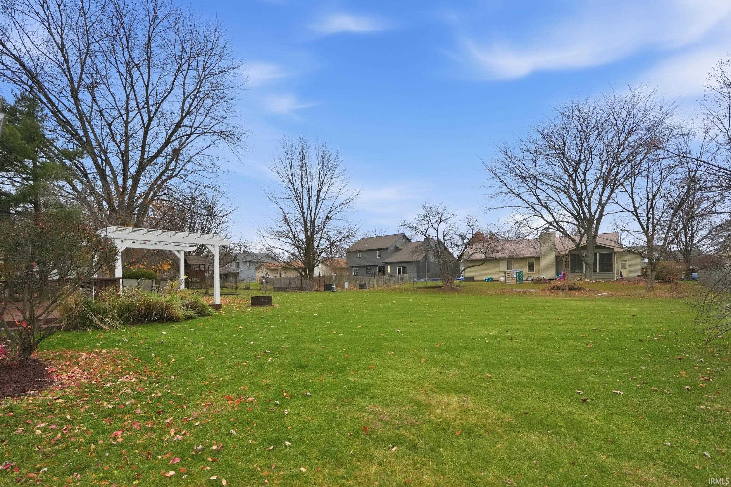 View of grassy yard featuring a pergola