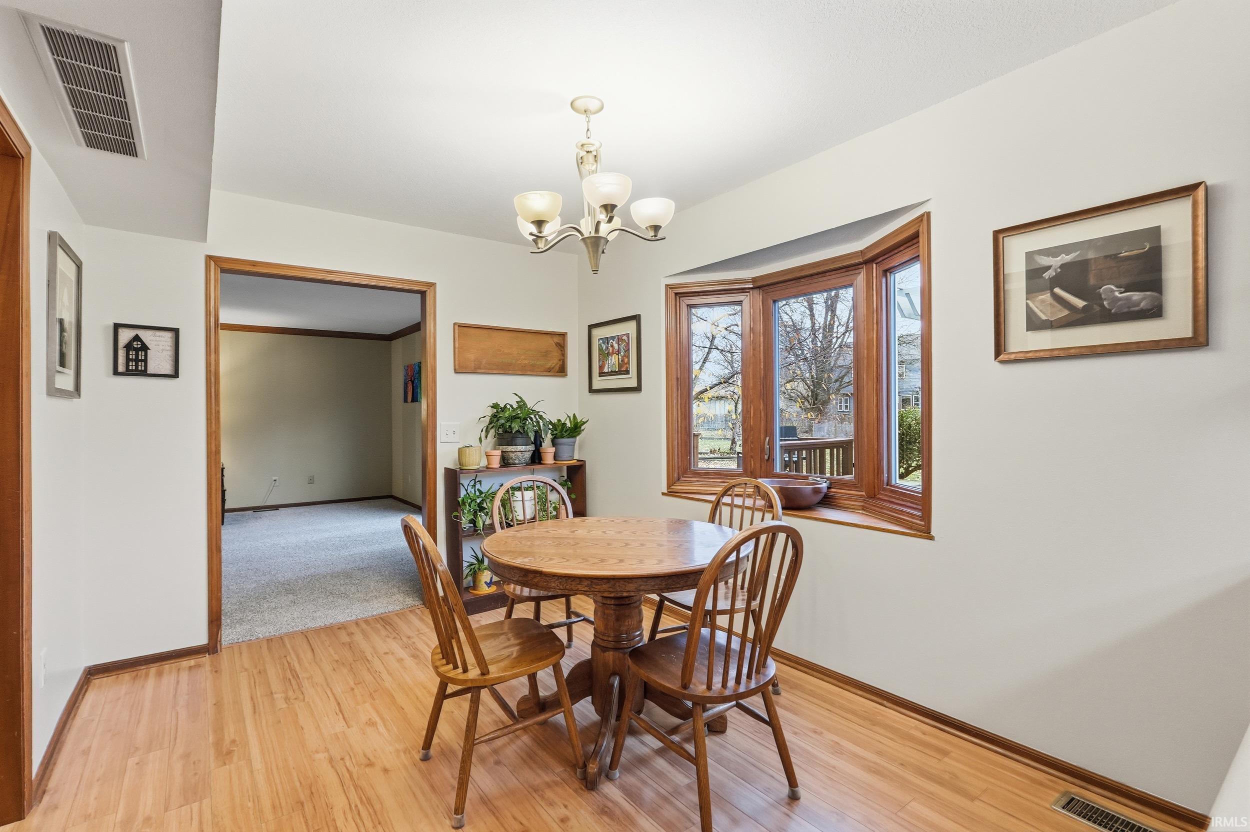 Dining room featuring a chandelier and light wood-style floors