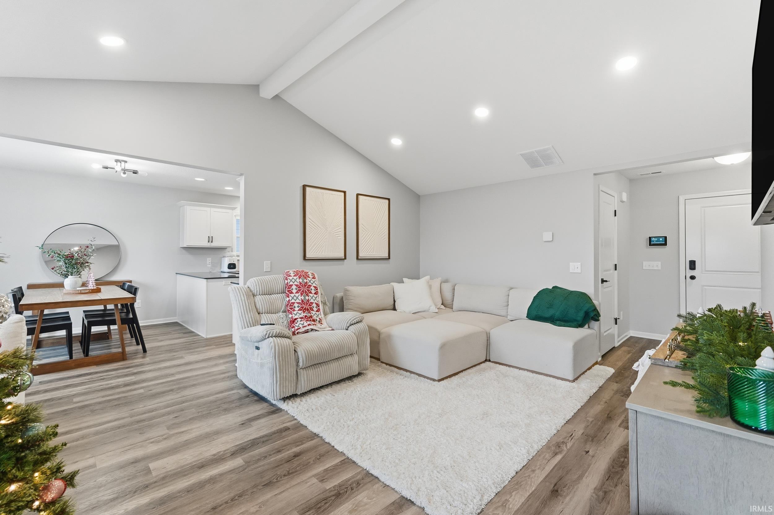 Living area featuring light wood-style floors and recessed lighting