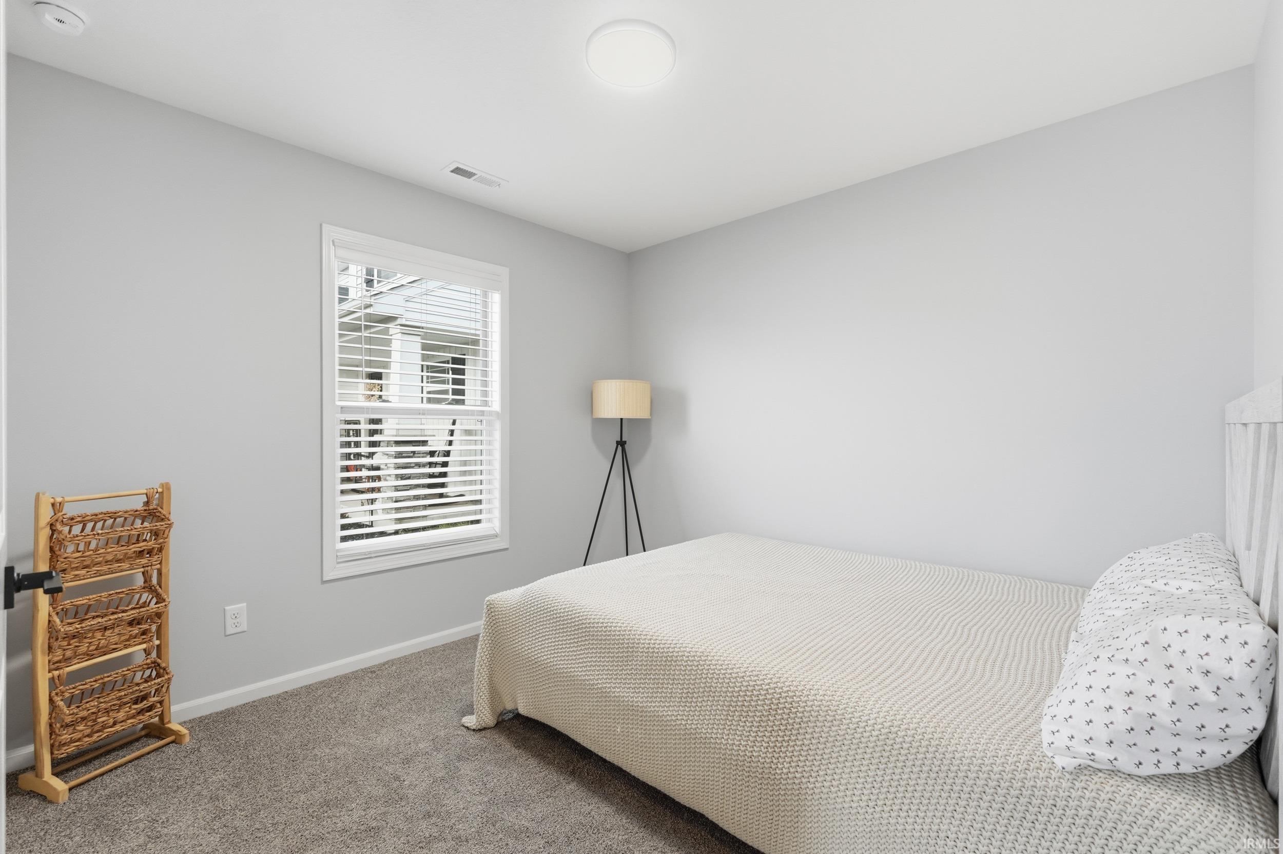 Carpeted bedroom featuring baseboards