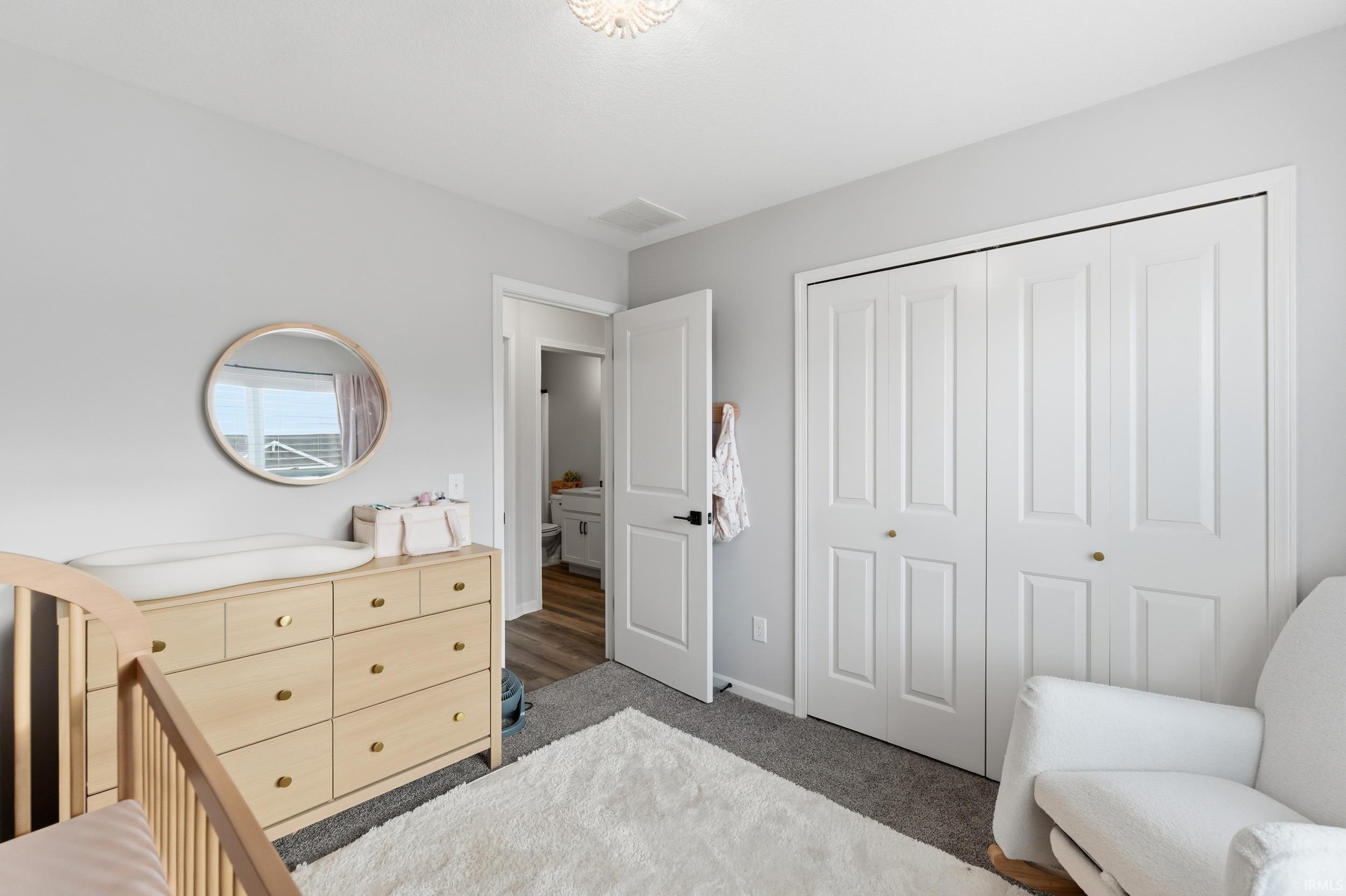 Bedroom with a closet and carpet flooring