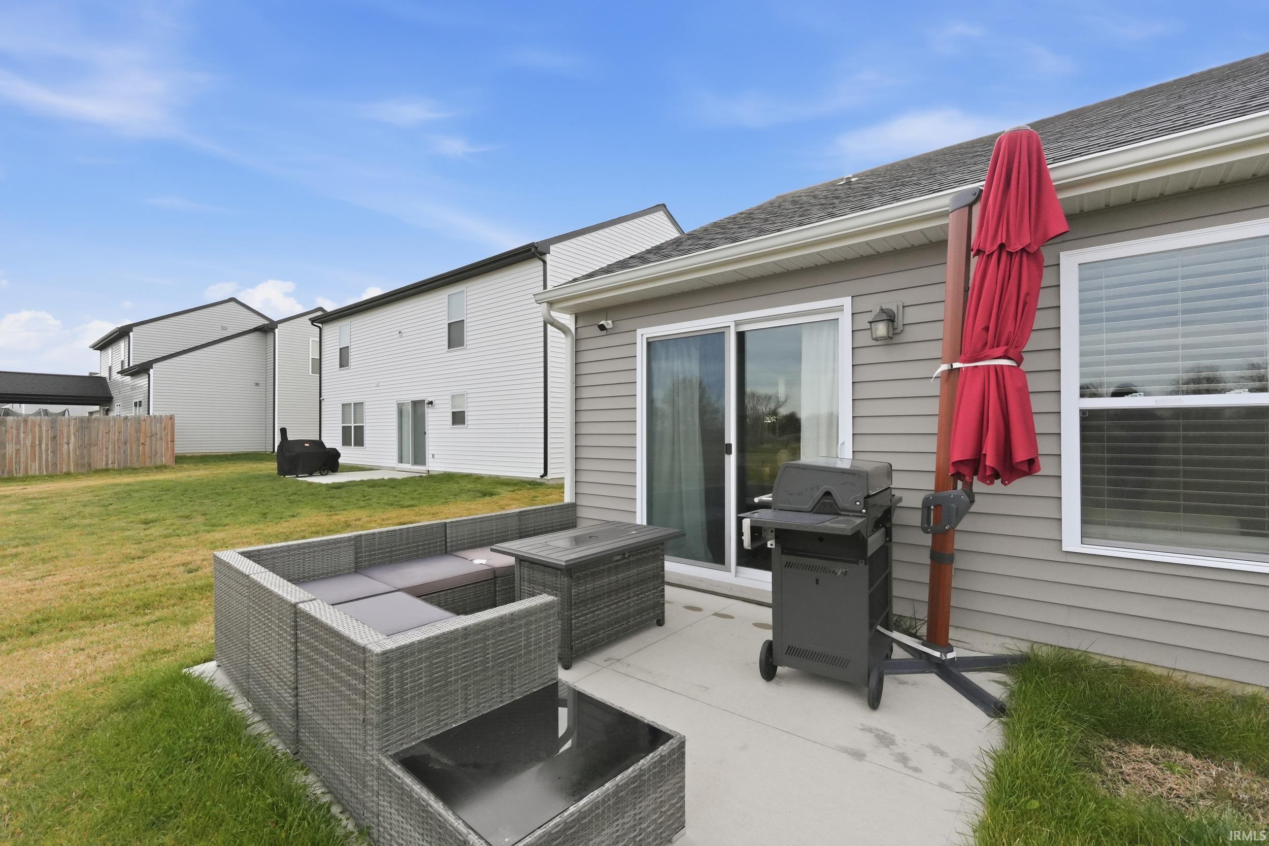 Back of property featuring a patio area and an outdoor living space