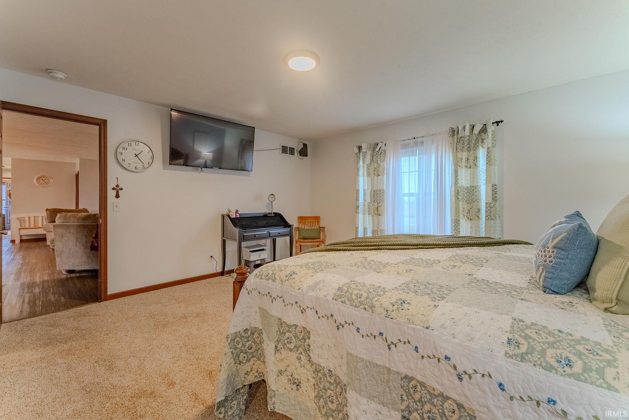 Bedroom featuring multiple windows and carpet flooring
