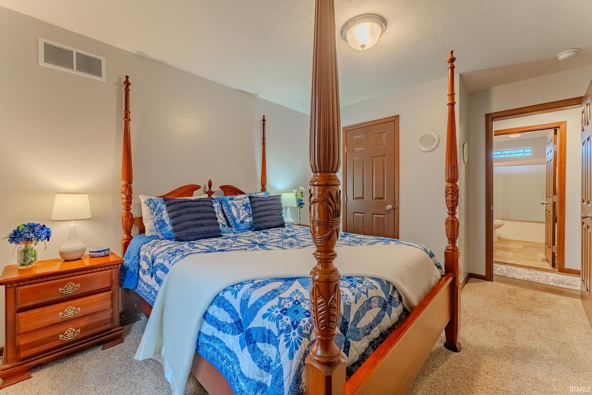 Bedroom with light colored carpet