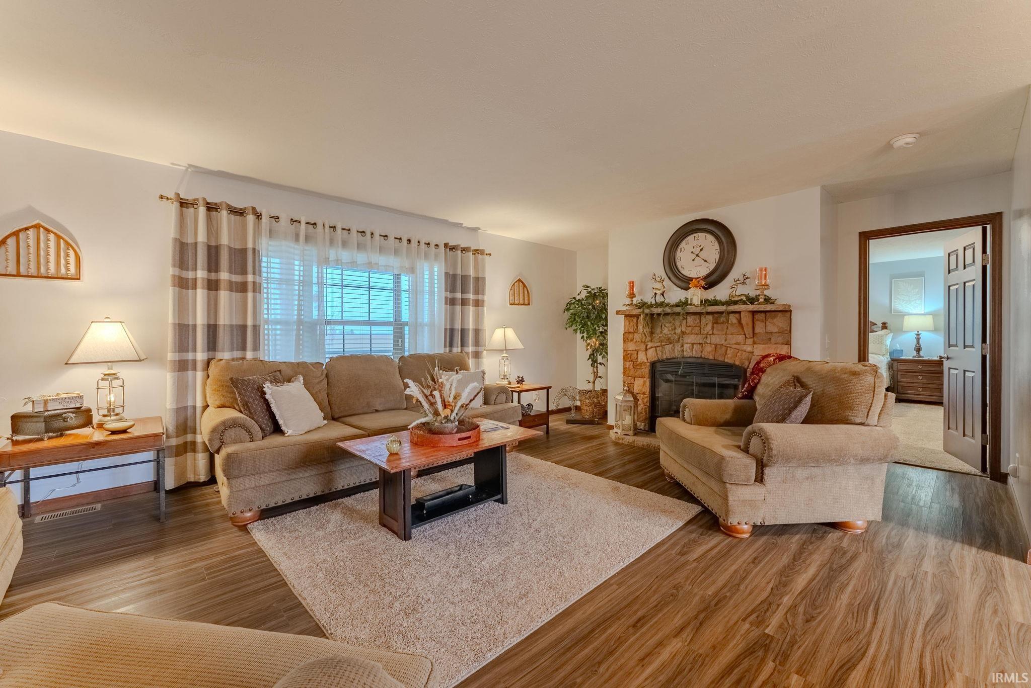 Living room with a fireplace and wood finished floors
