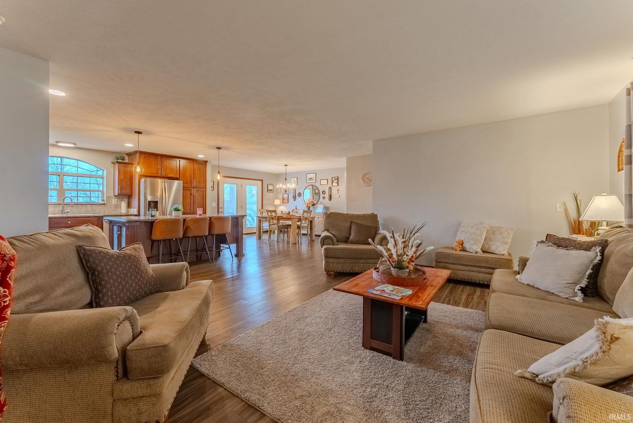 Living area featuring wood finished floors, a chandelier, and recessed lighting