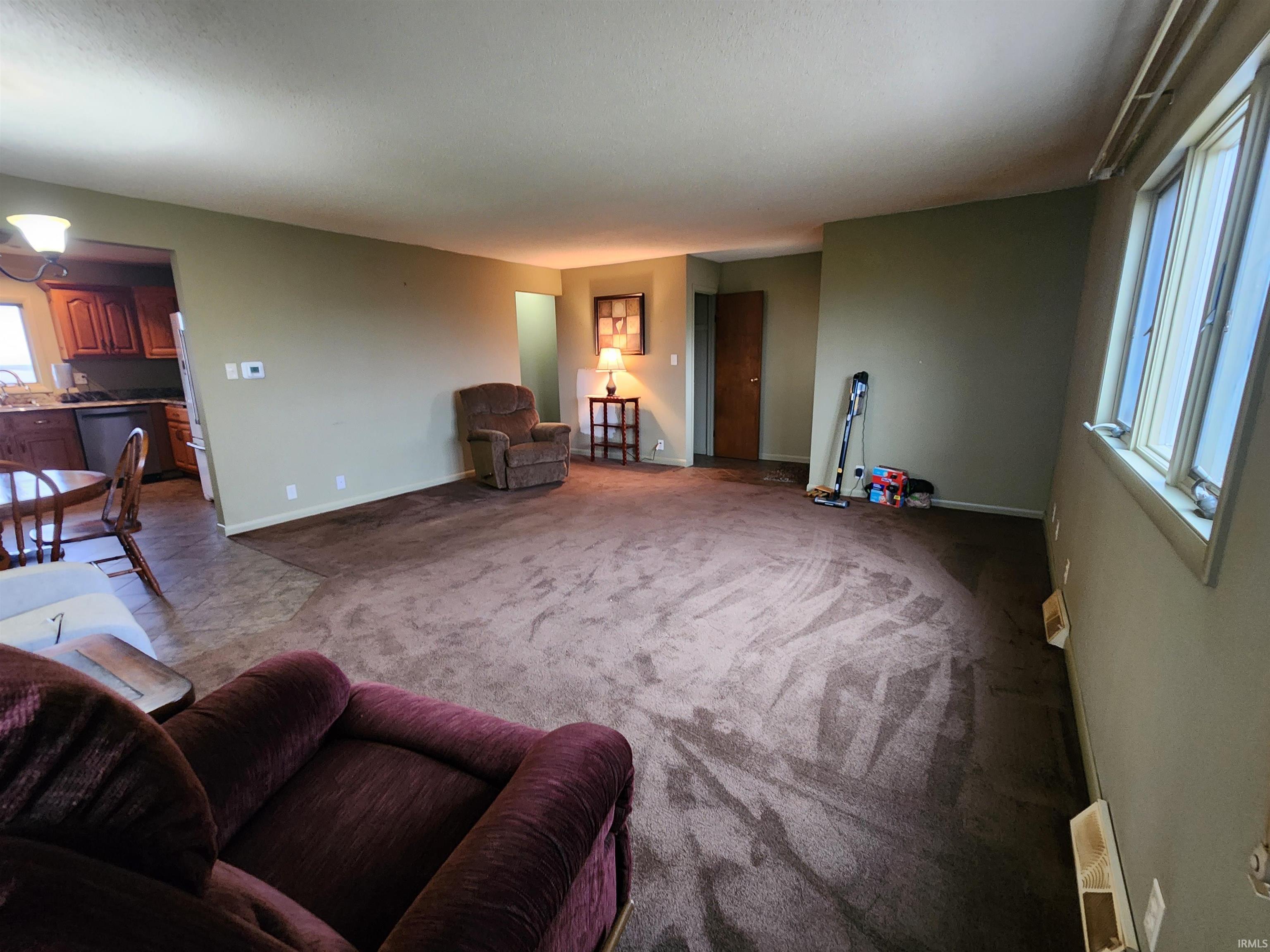 Living area featuring carpet and baseboards