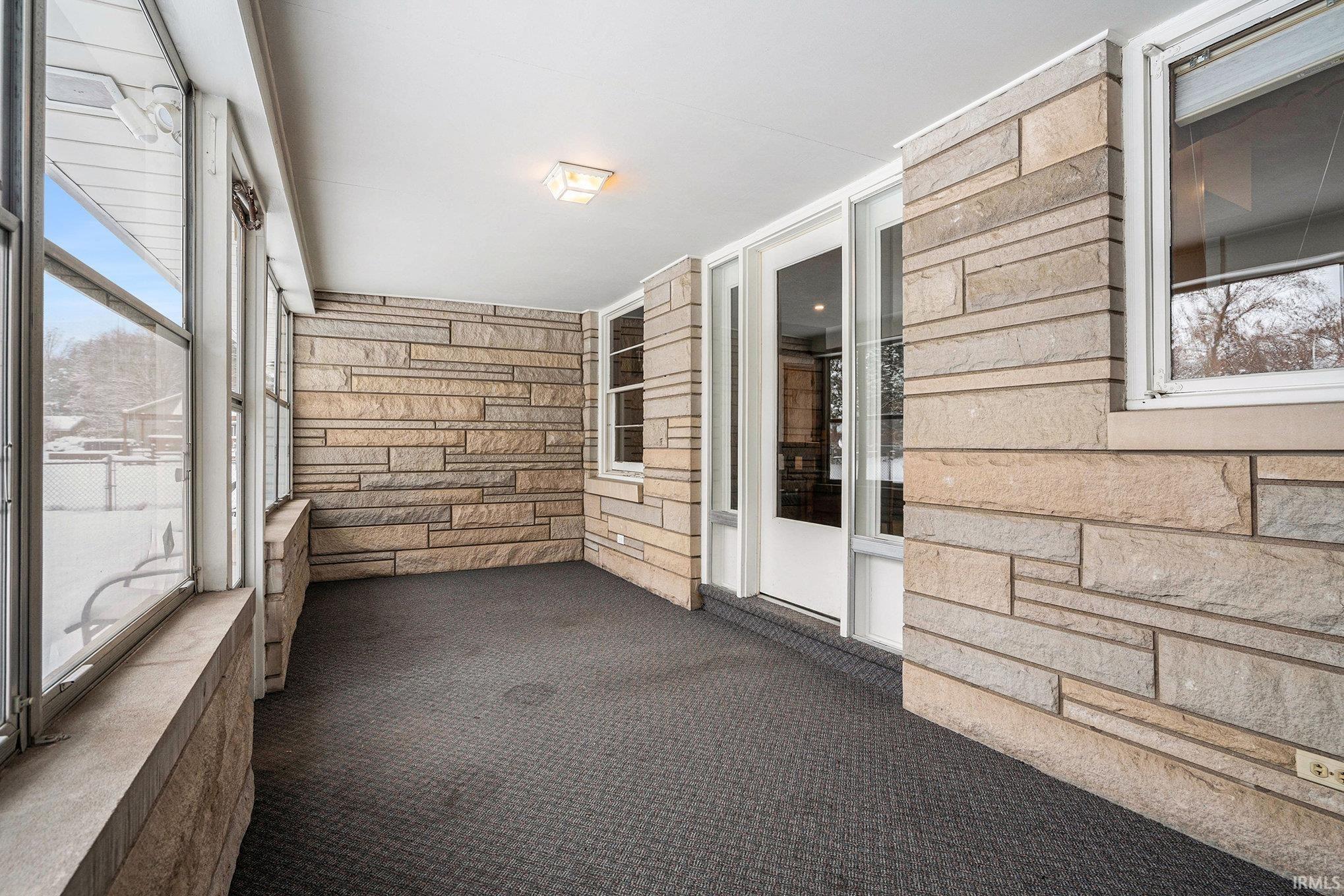 Unfurnished sunroom with a balcony