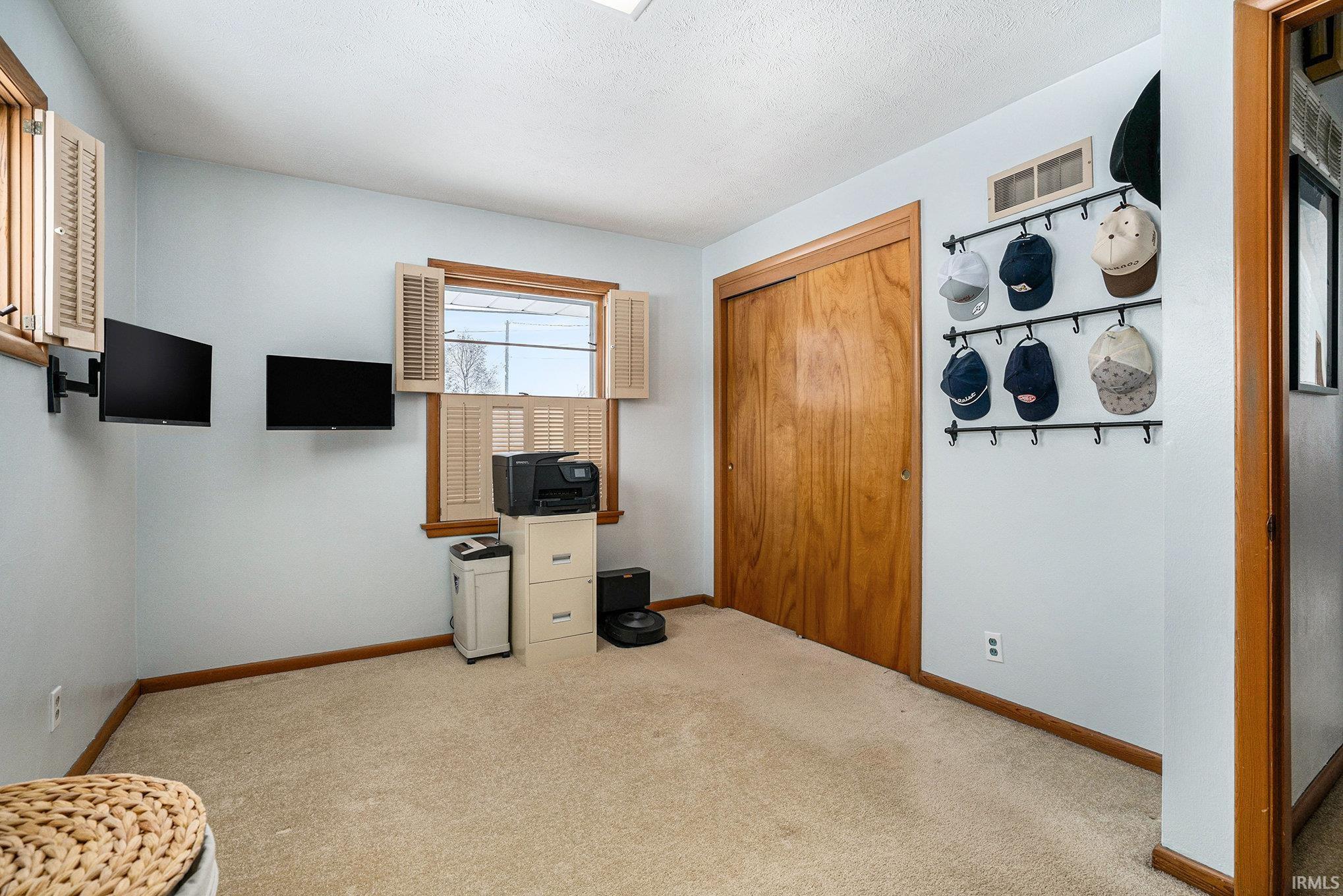 Office featuring light carpet and baseboards